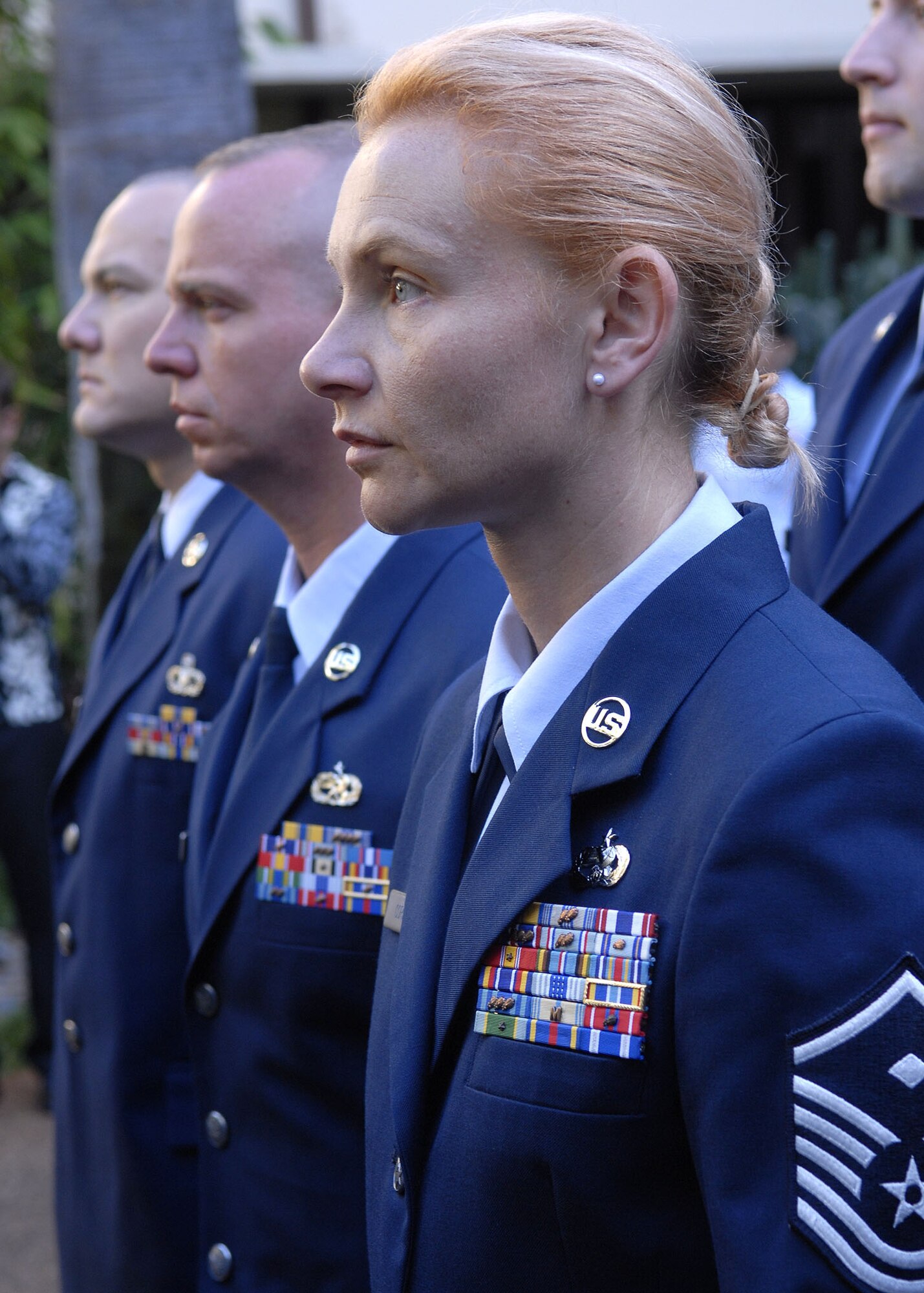 Members of Pacific Air Forces outstanding Airmen of the year, stand at attention in formation, during a wreath-laying ceremony, at the Courtyard of Heroes, Headquarters Pacific Air Forces, Joint Base Pearl Harbor Hickam, Hawaii, April 26, 2010. Gen. Gary North, Pacific Air Forces Commander, PACAF, Command Chief Master Sergeant Brooke McLean, and PACAF?s outstanding Airmen of the year presided over the ceremony honoring those who died at Hickam Air Field, Dec. 7, 1941. (U. S. Air Force photo/Tech. Sgt. Jerome S. Tayborn)