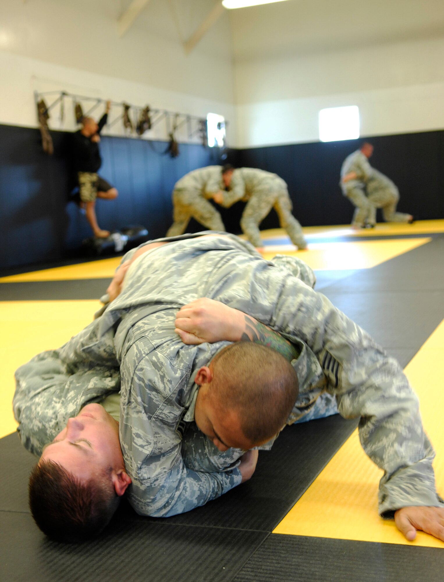 CAMP SAN LUIS OBISPO, Calif. -- Staff Sgt. Jarrett Pablo and Staff Sgt. Michael Elkins, Modern Army Combatives Program students practice techniques to overpower each other here Thursday, April 23, 2010. Since September 2009, the 30th Civil Engineer Squadron has sent 20 Airmen to attend the joint-service training to become instructors. (U.S. Air Force photo/Senior Airman Heather R. Shaw)