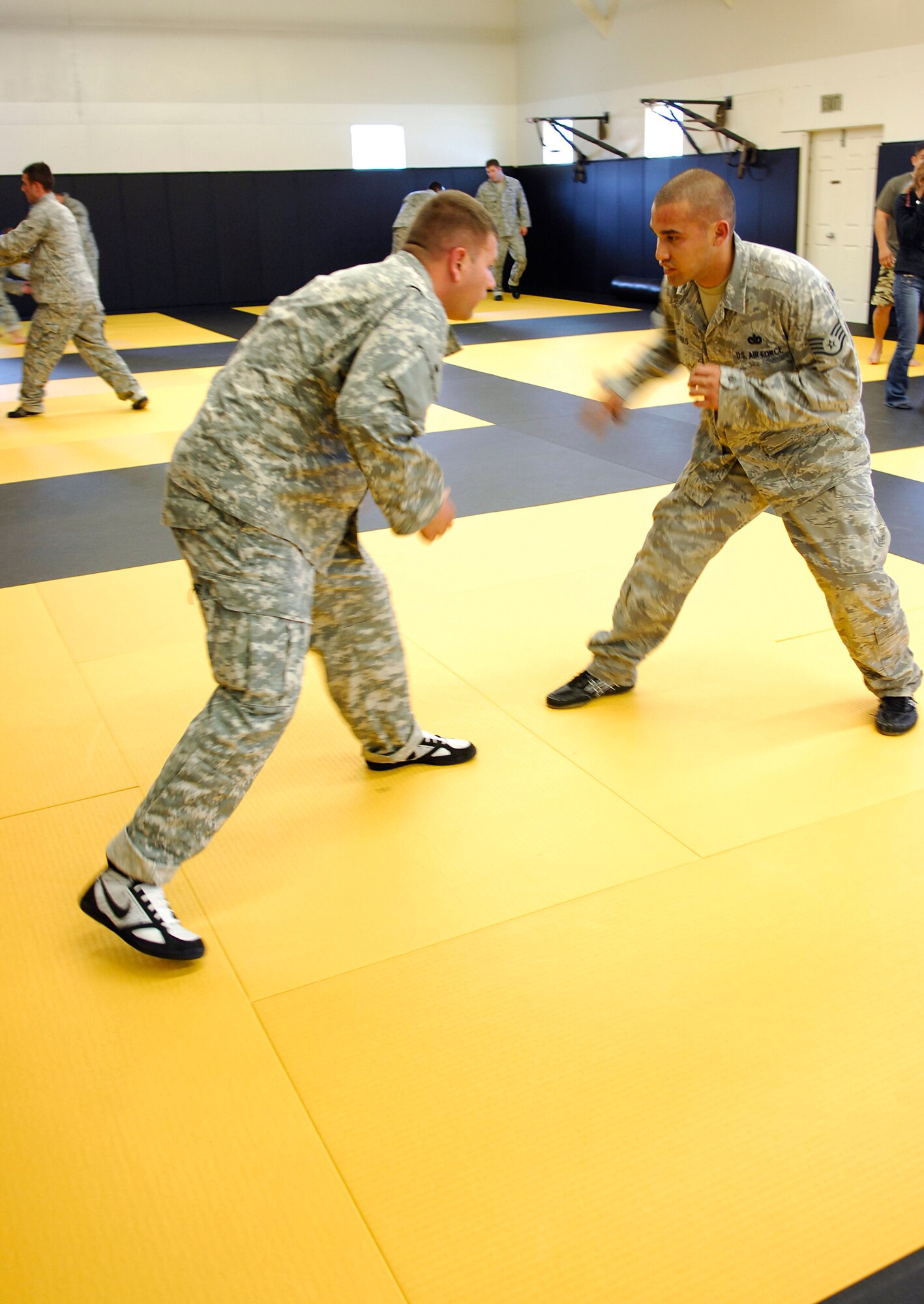CAMP SAN LUIS OBISPO, Calif. -- Awaiting the first move, Staff Sgt. Jarrett Pablo and Staff Sgt. Michael Elkins, Modern Army Combatives Program students practice combat skills here Thursday, April 22, 2010. Since September 2009, the 30th Civil Engineer Squadron has sent 20 Airmen to attend the joint-service training to become instructors.  (U.S. Air Force photo/Senior Airman Heather R. Shaw)