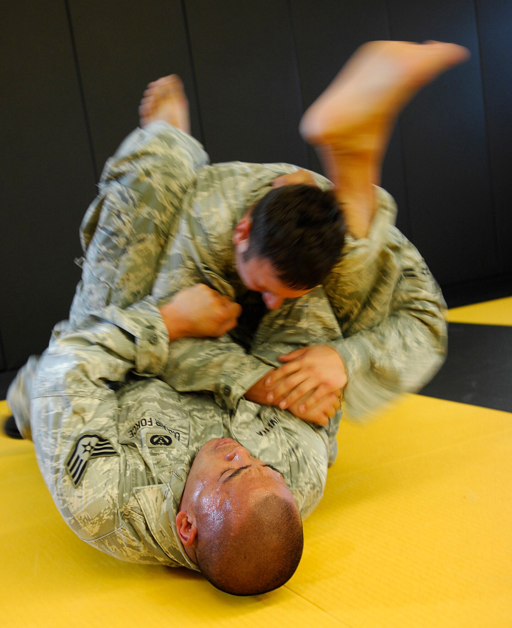 CAMP SAN LUIS OBISPO, Calif. -- Airman 1st Class Matthew Belmer and Staff Sgt. Jonathan Rivera, from the 30th Civil Engineer Squadron, use techniques learned from the Modern Army Combatives Program while practicing drills their moves here Thursday, April 22, 2010. The MACP training is a combination of Brazilian Jiu-Jitsu and standard combat skills. (U.S. Air Force photo/Senior Airman Heather R. Shaw)