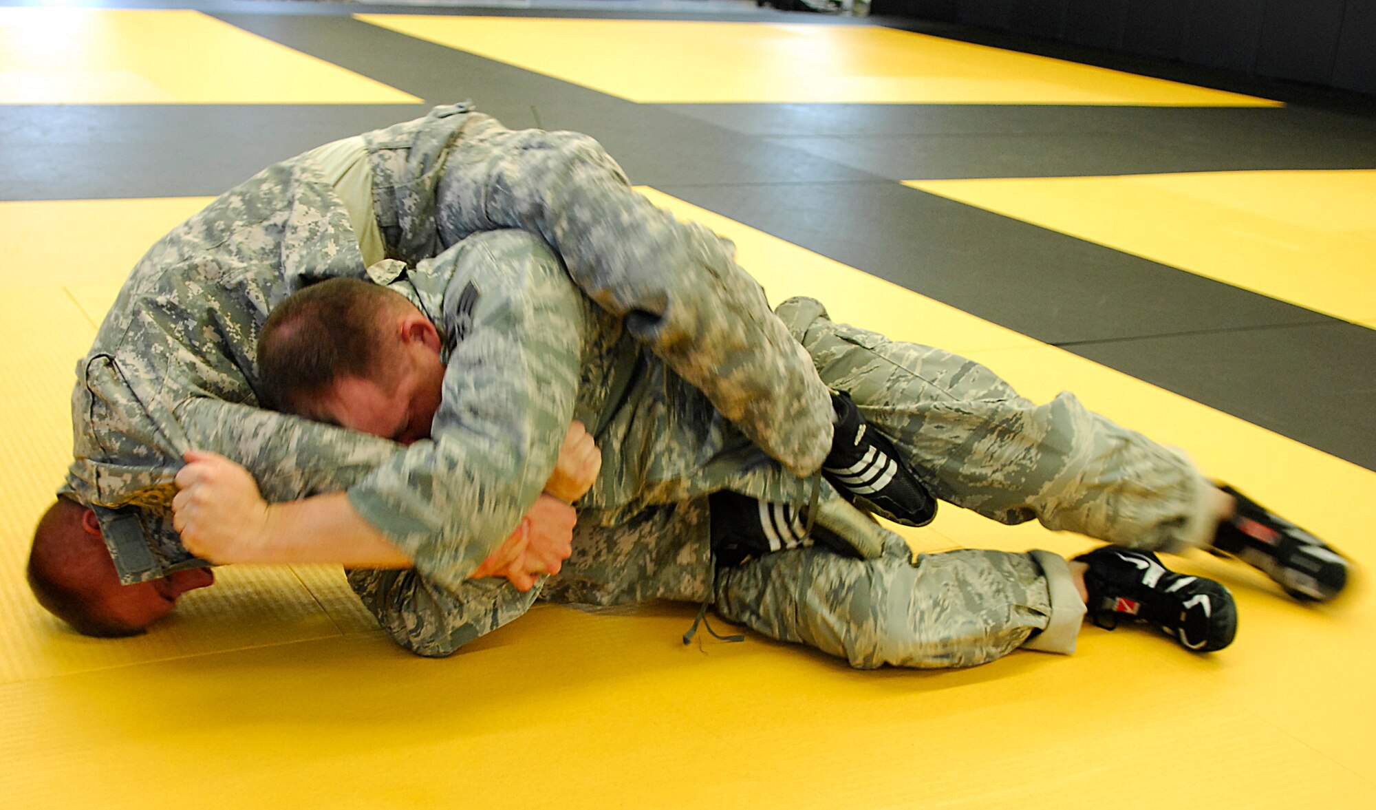 CAMP SAN LUIS OBISPO, Calif. -- Senior Airman Justin Egan, from the 30th Civil Engineer Squadron uses strategies learned during the Modern Army Combatives Program training in an attempt to overcome his opponent Spc. Anthony Michaelson here Thursday, April 22, 2010. The MACP training is a combination of Brazilian Jiu-Jitsu and standard combat skills. (U.S. Air Force photo/Senior Airman Heather R. Shaw)