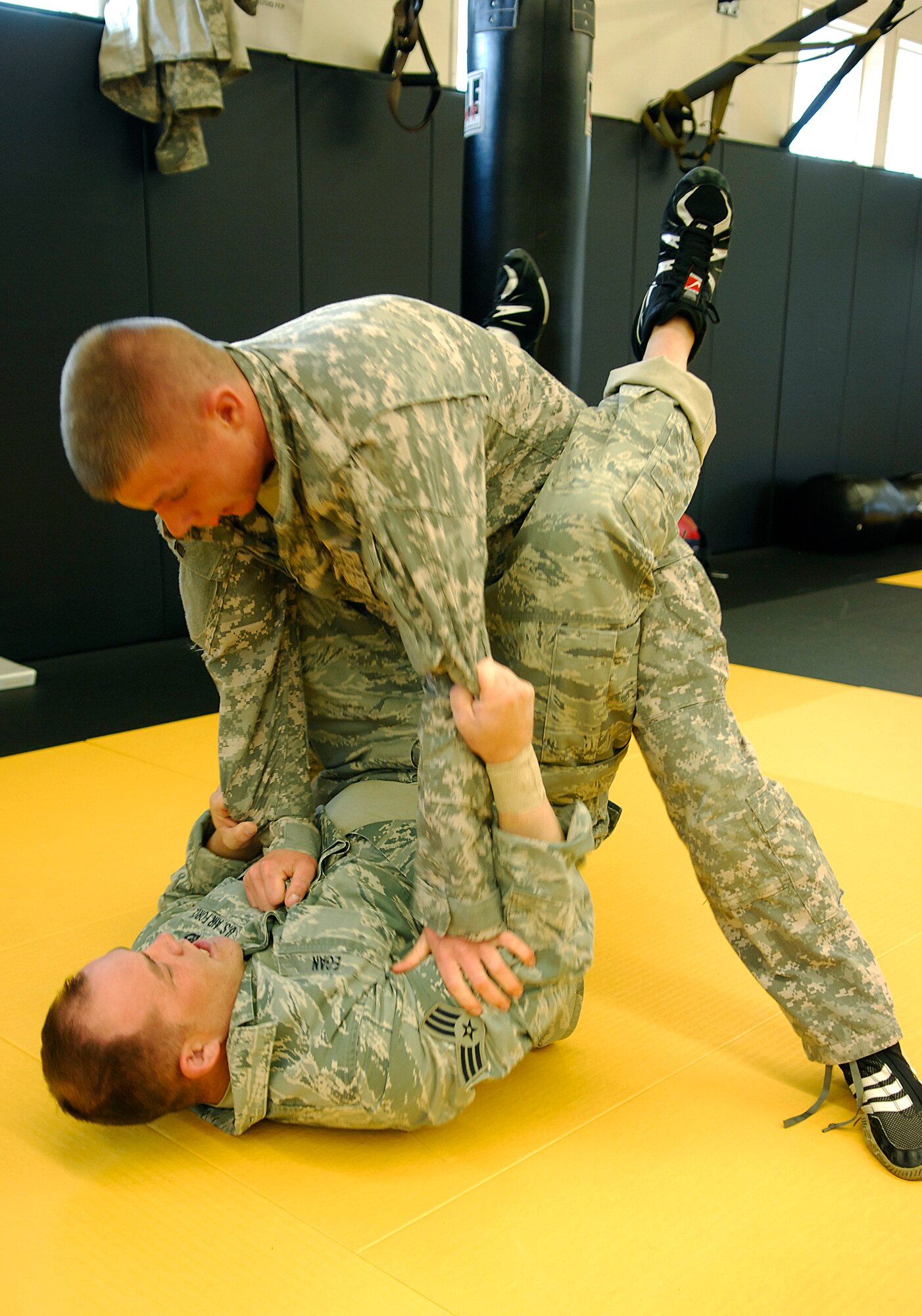 CAMP SAN LUIS OBISPO, Calif. -- During a Modern Army Combatives Program training exercise, Spc. Anthony Michaelson, from Camp San Luis Obispo and Senior Airman Justin Egan, from the 30th Civil Engineer Squadron practice combat tactics here Thursday, April 22, 2010. Twenty Airmen from the 30th CES are now certified to instruct MACP. (U.S. Air Force photo/Senior Airman Heather R. Shaw)