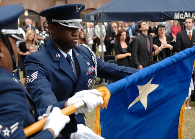 Staff Sgt. Akeem Parks retires U.S. Air Force Brig. Gen. Thomas R. Mikolajcik's flag during the funeral ceremony April 24, 2010, at the Cathedral of St. John the Baptist in Charleston, S.C. In 2009, the Amyotrophic Lateral Sclerosis Association South Carolina Chapter honored the general and his family, describing them as role models for those living with ALS. Sergeant Parks is an honor guard member from the 628th Logistics Readiness Squadron. (U.S. Air Force photo/Senior Airman Timothy Taylor)