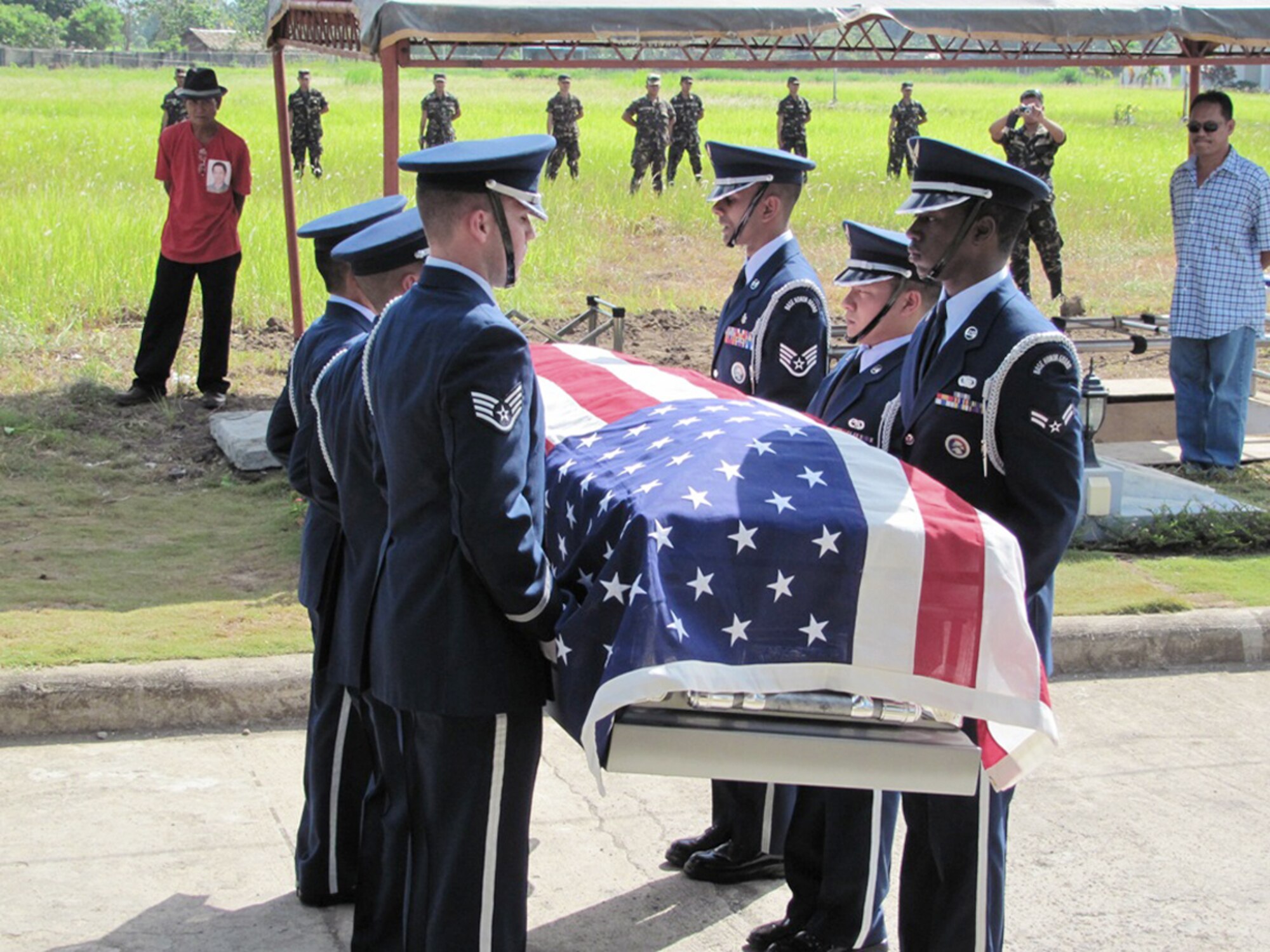 Members of the Kadena Air Base Honor Guard hold the flag-draped casket of Tech. Sgt. Raymond Natividad during a funeral detail April 27, 2010, in Bacolod, Philippines. (U.S. Air Force photo/Tech. Sgt. Brian Roberts) 