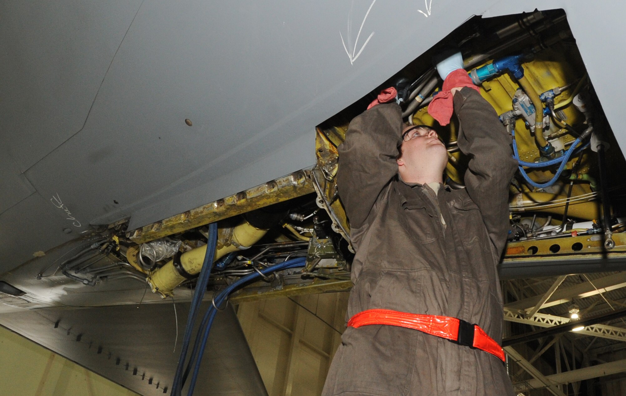 Airman 1st Class Clay Herbson, 22nd Maintenance Squadron hydraulics systems apprentice, fixes the hydraulic relief valves on a KC-135 Stratotanker aircraft April 8, 2010, McConnell Air Force Base, Kan. Airman Herbson must first fix the valves in order for structural maintenance Airmen to repair cracked brackets within the tail section of the aircraft. (U.S. Air Force photo/Airman 1st Class Andrea Salazar)