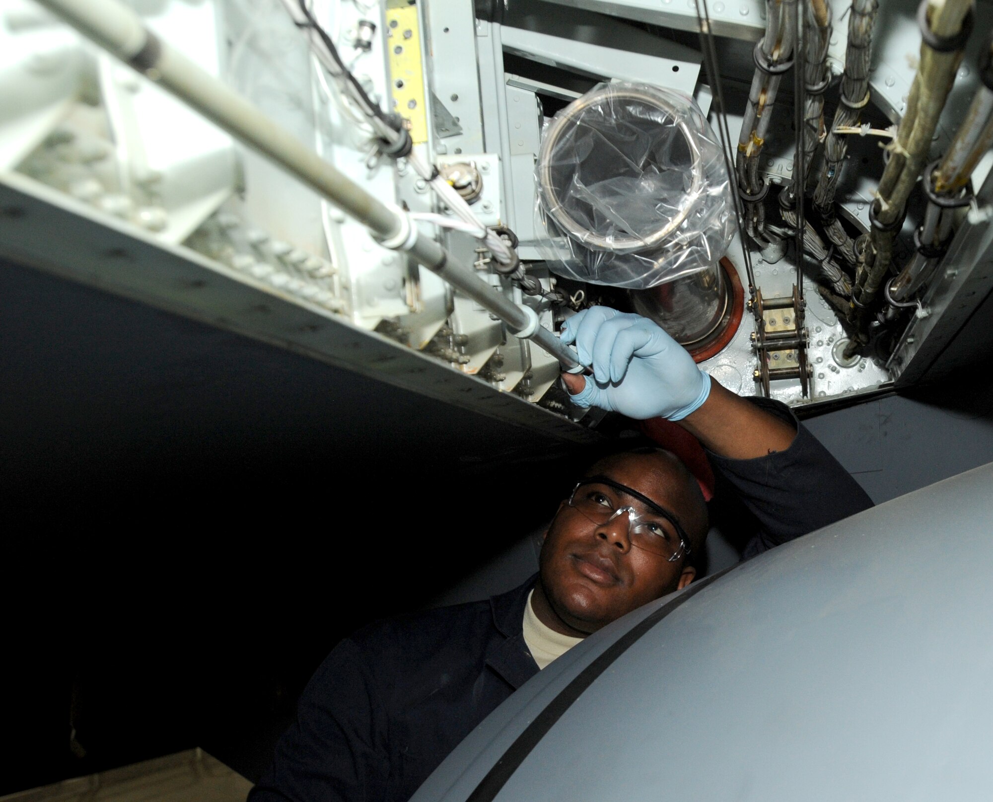Airman 1st Class Sean Moore, 22nd Maintenance Squadron hydraulics systems specialist, checks for dents on a section of hydraulic tubing installed on the wing of a KC-135 Stratotanker aircraft April 8, 2010, McConnell Air Force Base, Kan. A dented line can create leaks in the hydraulic system resulting in a decrease of pressure and failure of hydraulic systems. (U.S. Air Force photo/Airman 1st Class Andrea Salazar) 
