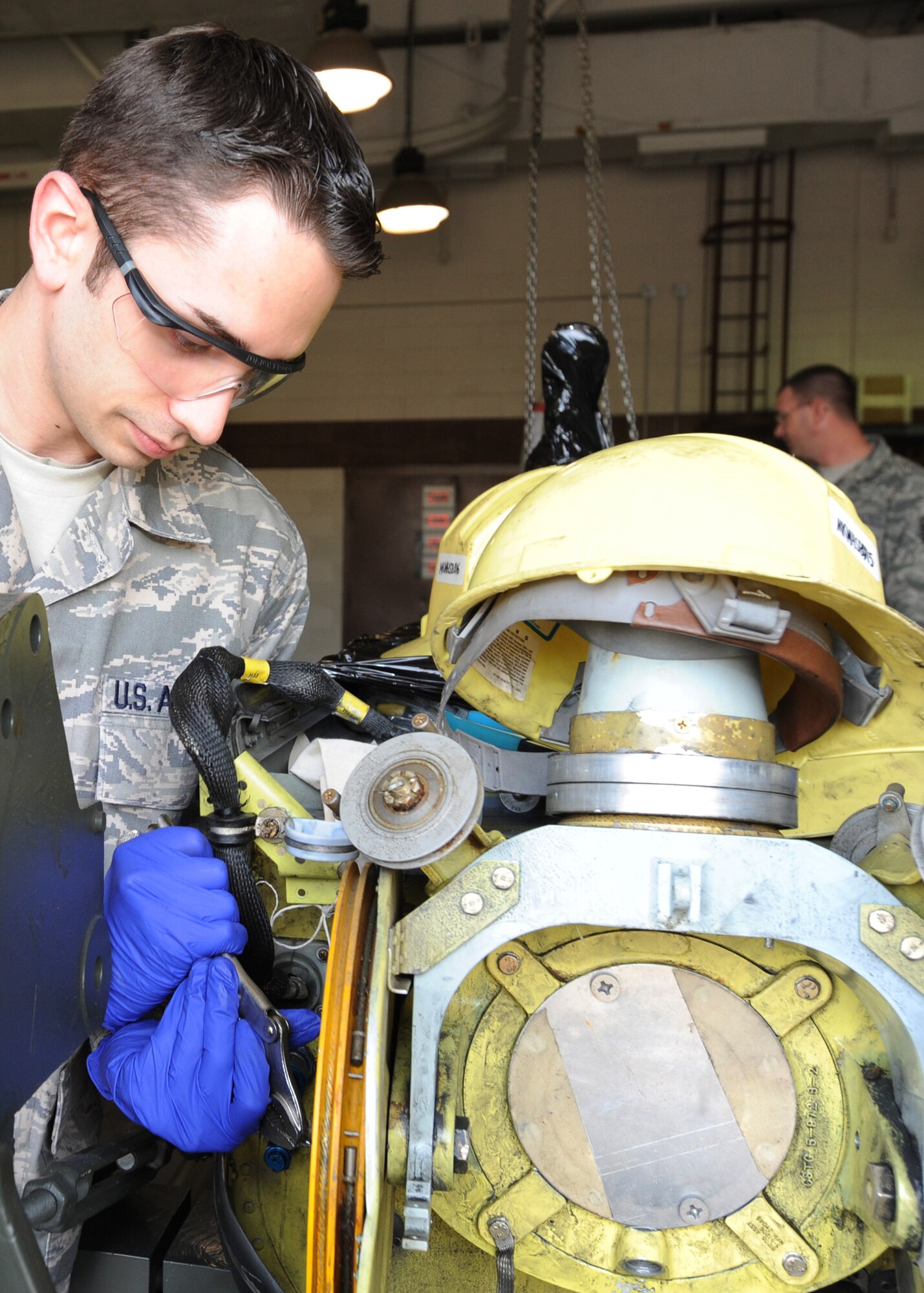 Airman 1st Class Matthew Gangi, 22nd Maintenance Squadron hydraulics systems specialist, fastens a bolt to secure a broken boom to a shipping crate April 8, 2010, McConnell Air Force Base, Kan. Due to structural damage to this boom, it will be shipped to Tinker AFB, Okla., where it will be fixed and sent to any available KC-135 Stratotanker base in need of one.  (U.S. Air Force photo/Airman 1st Class Andrea Salazar)