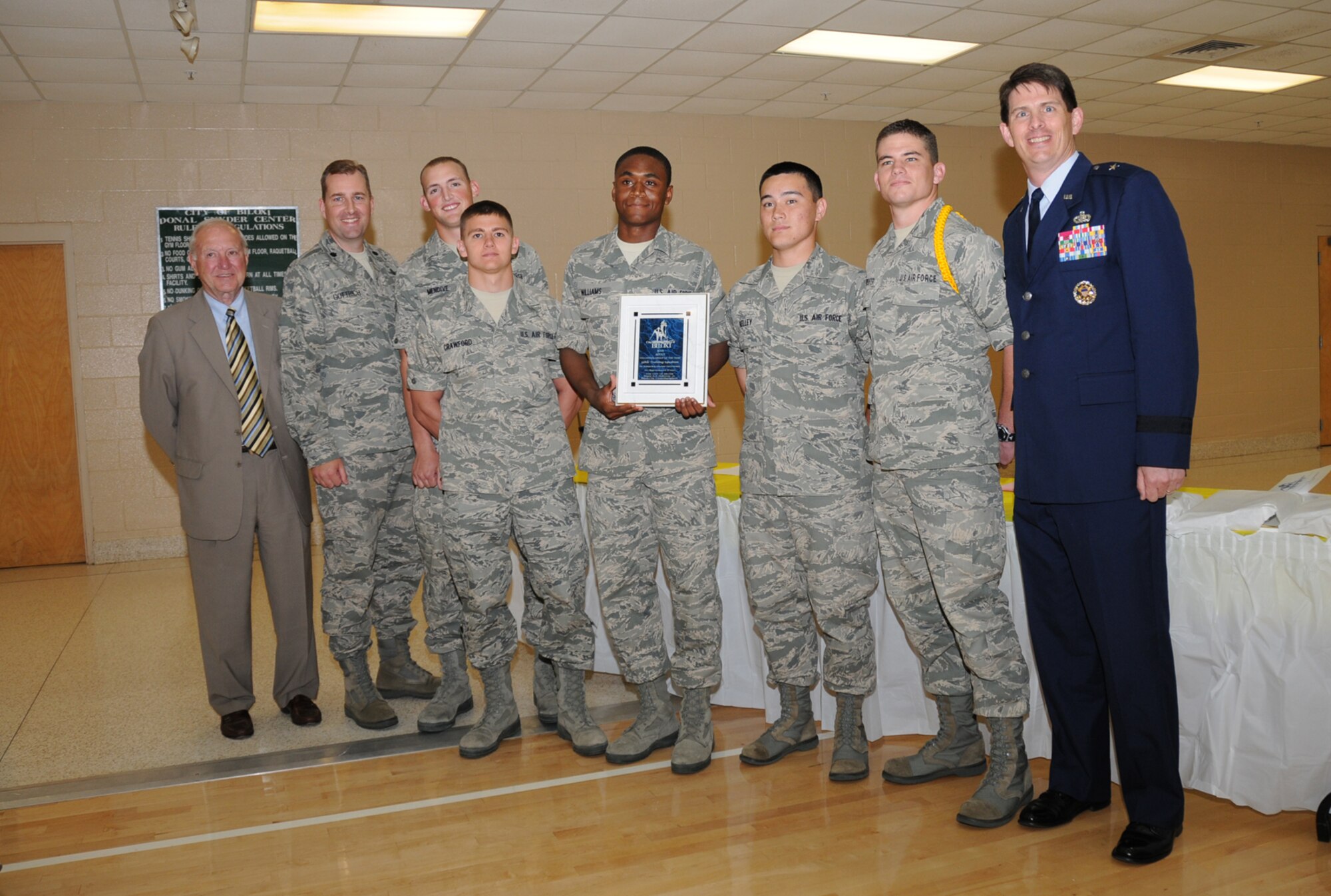 From left, Mayor Holloway; Colonel Gottrich; Airmen Basic Kirk Mendive, Stephen Crawford, Stephon Williams, and John Kelly; Airmen 1st Class Buck Carpenter and General Dickinson display the 338th TRS’ award for Biloxi’s volunteer group of the year.  Airmen Mendive, Crawford, Williams, Kelly and Carpenter are students in the squadron.  (U.S. Air Force photo by Kemberly Groue)