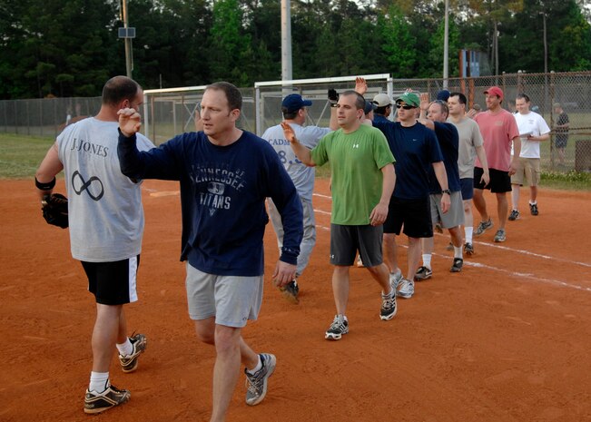 Members from the 701st Airlift Squadron and Boeing team line up to shake hands and high-five one another after a good game at the softball field April 23, 2010, on Joint Base Charleston, S.C. Boeing defeated the 701st Airlift Squadron 10-9. (U.S. Air Force photo/Senior Airman Timothy Taylor)