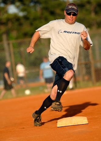 Mr. Kurt Hollensteiner rounds second base after a teammate hits a line drive to right field at the softball field April 23, 2010, on Joint Base Charleston, S.C. Mr.Hollensteiner is a mechanic for Boeing. (U.S. Air Force photo/Senior Airman Timothy Taylor)

