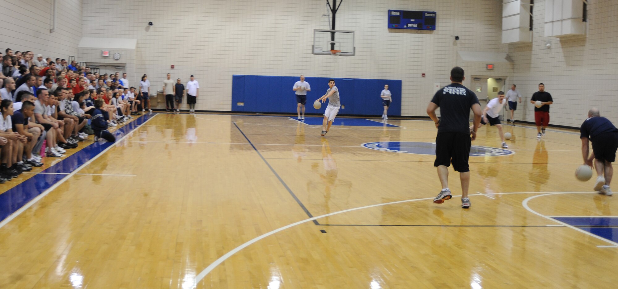 Team McConnell Airmen watch a dodge ball tournament between the 22nd Medical Support Squadron and the 22nd Civil Engineer Squadron, at the base’s fitness center April 22, 2010, McConnell Air Force Base, Kan. Twenty two, six member teams, composed of different squadrons of Team McConnell Airmen participated in the dodge ball tournament as part of McConnell’s Warrior Day. McConnell’s fitness center hosted the event to promote physical fitness and display facilities they have to offer Team McConnell Airmen and families. (U.S. Air Force photo/Senior Airman Maria Ruiz)