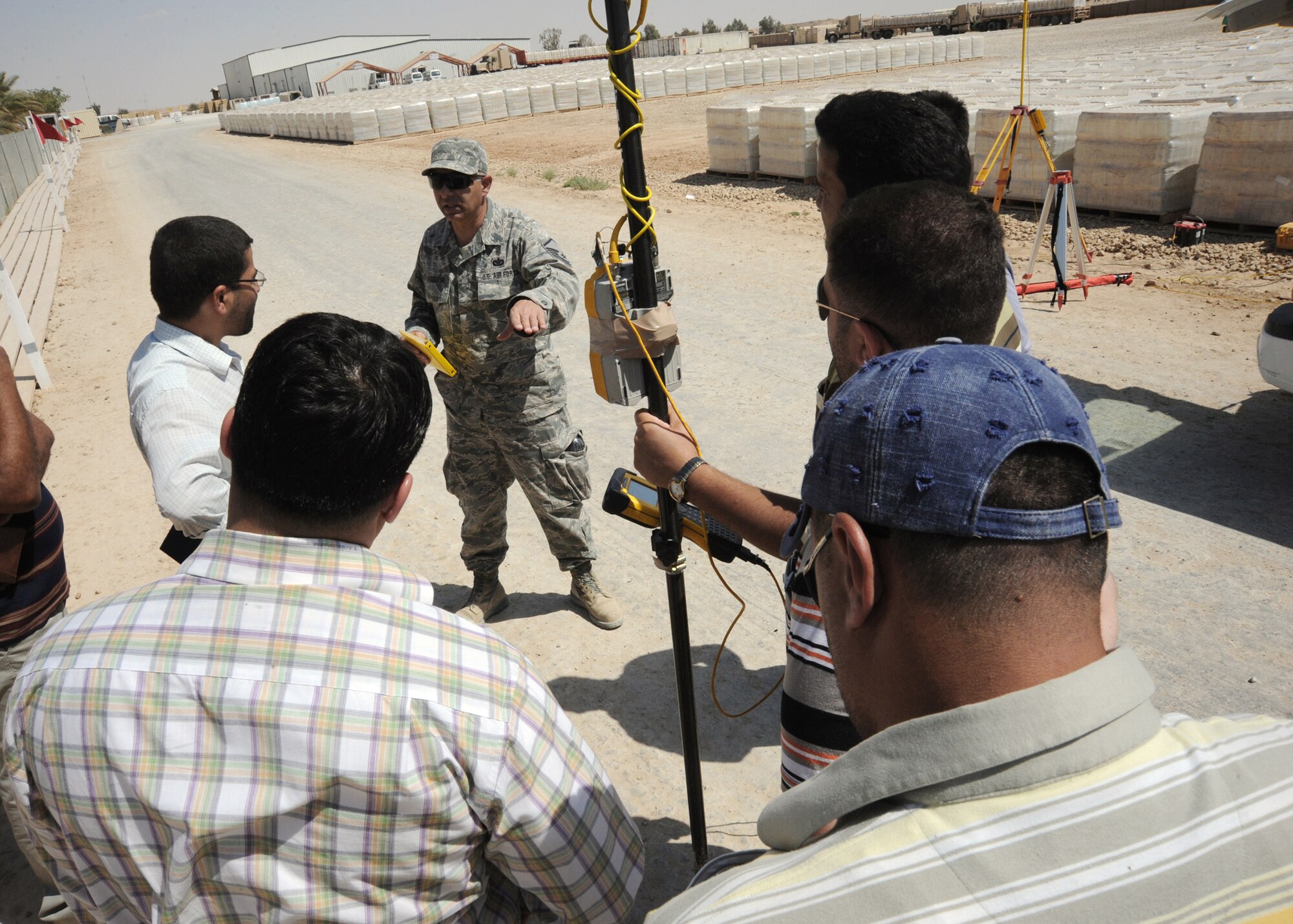 Master Sgt. Varoujan Garabedian teaches the Iraqi field and engineering team how to input data into the global positioning station controller April 19, 2010, at Al Asad Air Base, Iraq. Sergeant Garabedian is an engineering assistant for 732nd Expeditionary Prime Beef Squadron. (U.S. Air Force photo/Master Sgt. Trish Bunting)