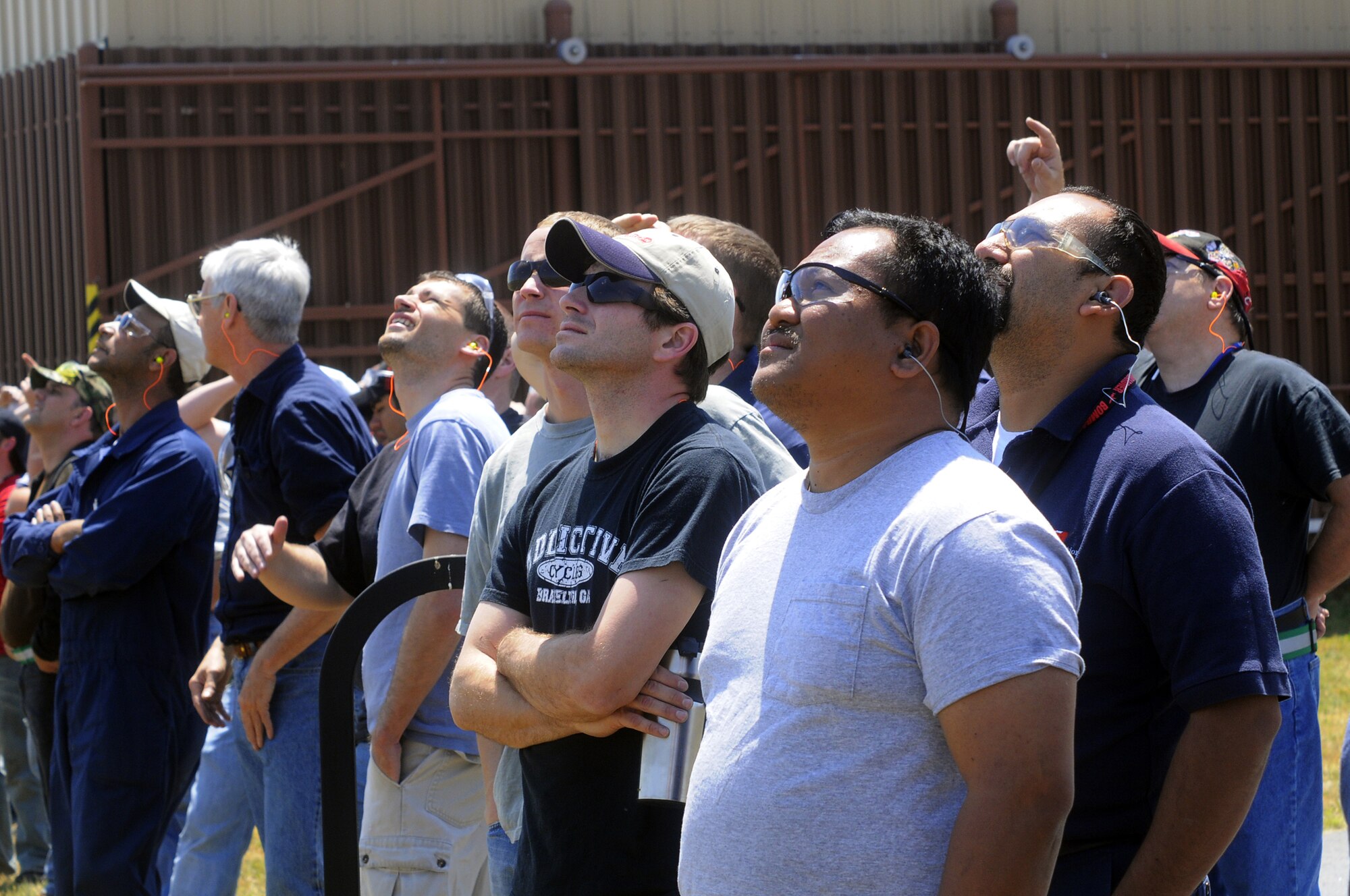 Members of the rewire crew take a few moments to watch the take-off of the 1st rewired F-15. U. S. Air Force photo by Sue Sapp