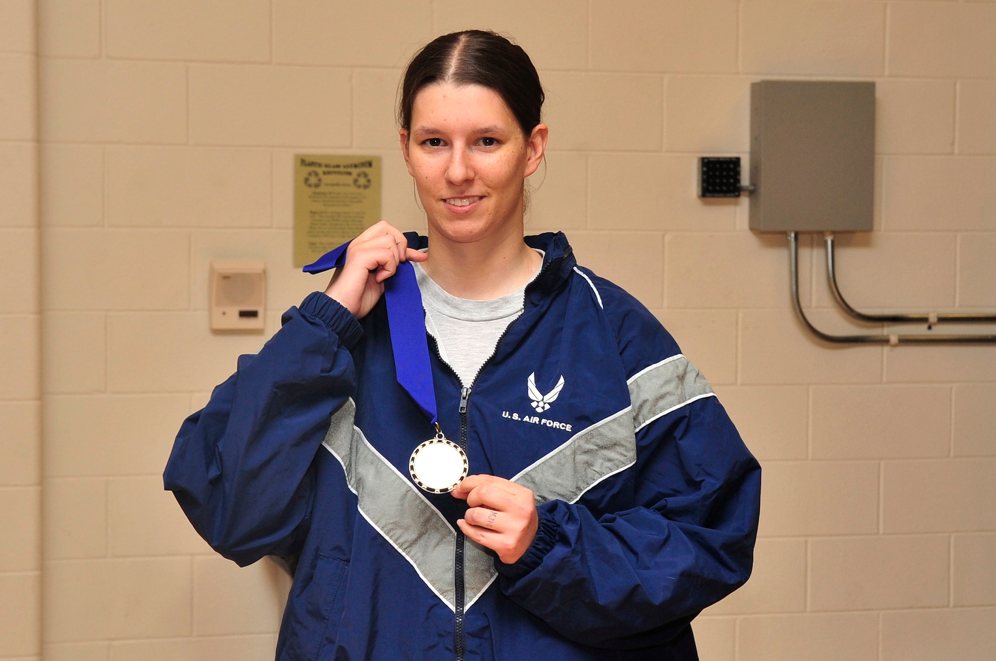 BUCKLEY AIR FORCE BASE, Colo. -- Kaitlin Mannino receives an award for her excellent performance in the Push-up / Sit-up competition at the base fitness center April 21. Mannino won in her age group for the sit-up portion of the competition with 56 sit-ups. (U.S. Air Force Photo by Airman 1st Class Manisha Vasquez)