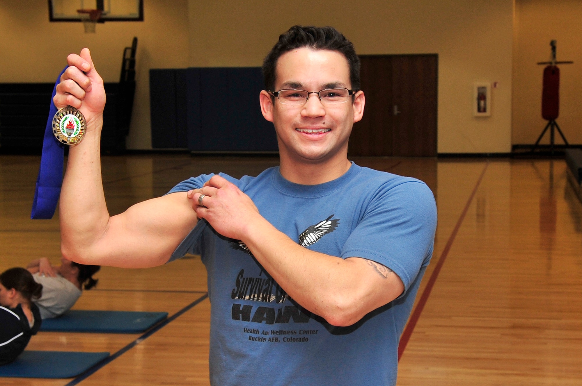 BUCKLEY AIR FORCE BASE, Colo. -- Jesse Cash receives an award for his excellent performance in the Push-up / Sit-up competition here April 21. Cash did 101 push-ups to win his age group. (U.S. Air Force Photo by Airman 1st Class Manisha Vasquez)