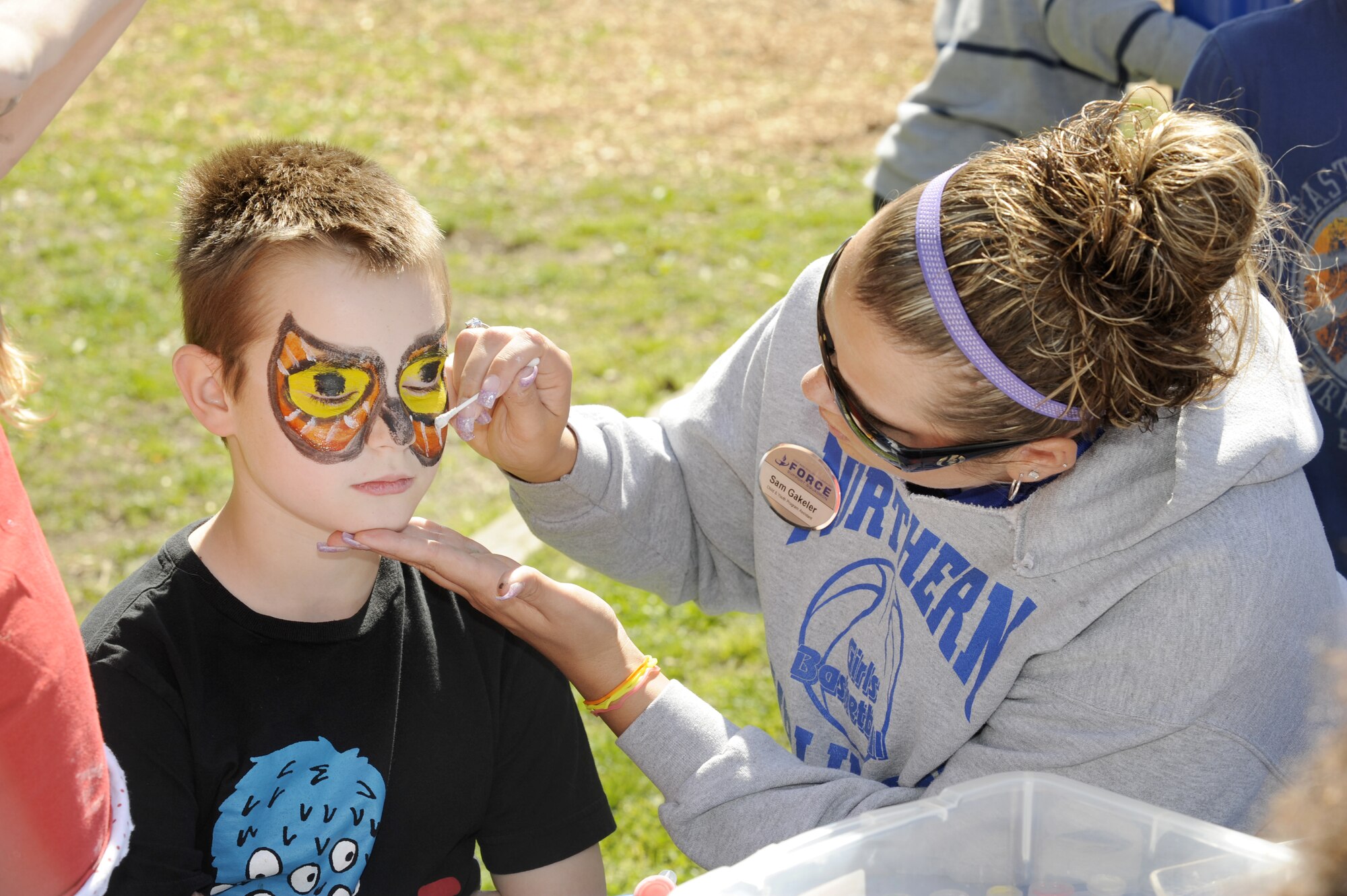 Eric Greyersen, 10, son of Master Sgt. Travis and Darla Greyersen, had colorful designs painted onto his face by Sam Gakeler, Youth Program Assistant, during the “Month of the military child and fit family” event held at the Joint Base McGuire-Dix-Lakehurst Youth Center April 23. The event included games, food and free prizes. (U.S. Air Force photo/Carlos Cintron)
