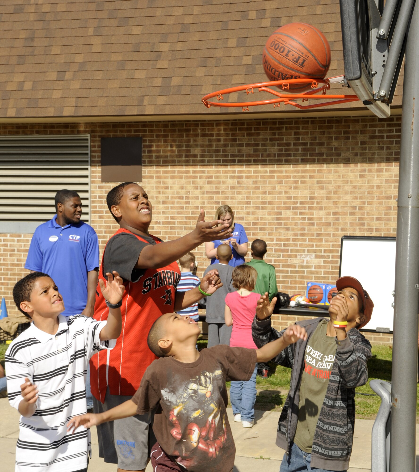 A group of children play a game of basketball at the Youth Center on Joint Base McGuire-Dix-Lakehurst during the “Month of the military child and fit family” event April 22. The event included games, food and free prizes. (U.S. Air Force photo/Carlos Cintron)