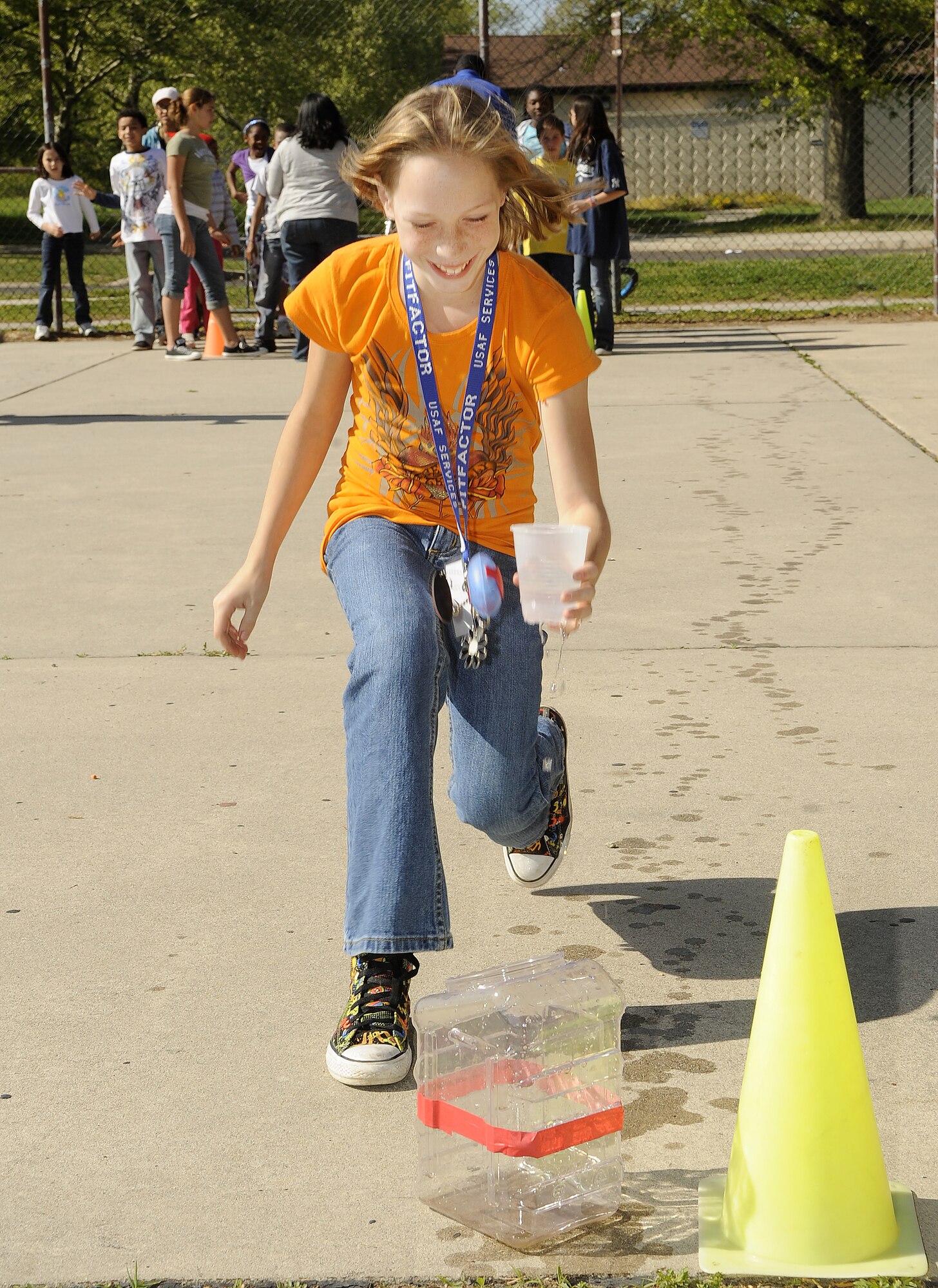 Kelsey Biggs, 10, daughter of Johnny and Regina Biggs, participates in a water relay race during the “Month of the military child and fit family” event held at the Joint Base McGuire-Dix-Lakehurst Youth Center April 23. Activities included face painting, basketball games and relay races. (U.S. Air Force photo/Carlos Cintron)