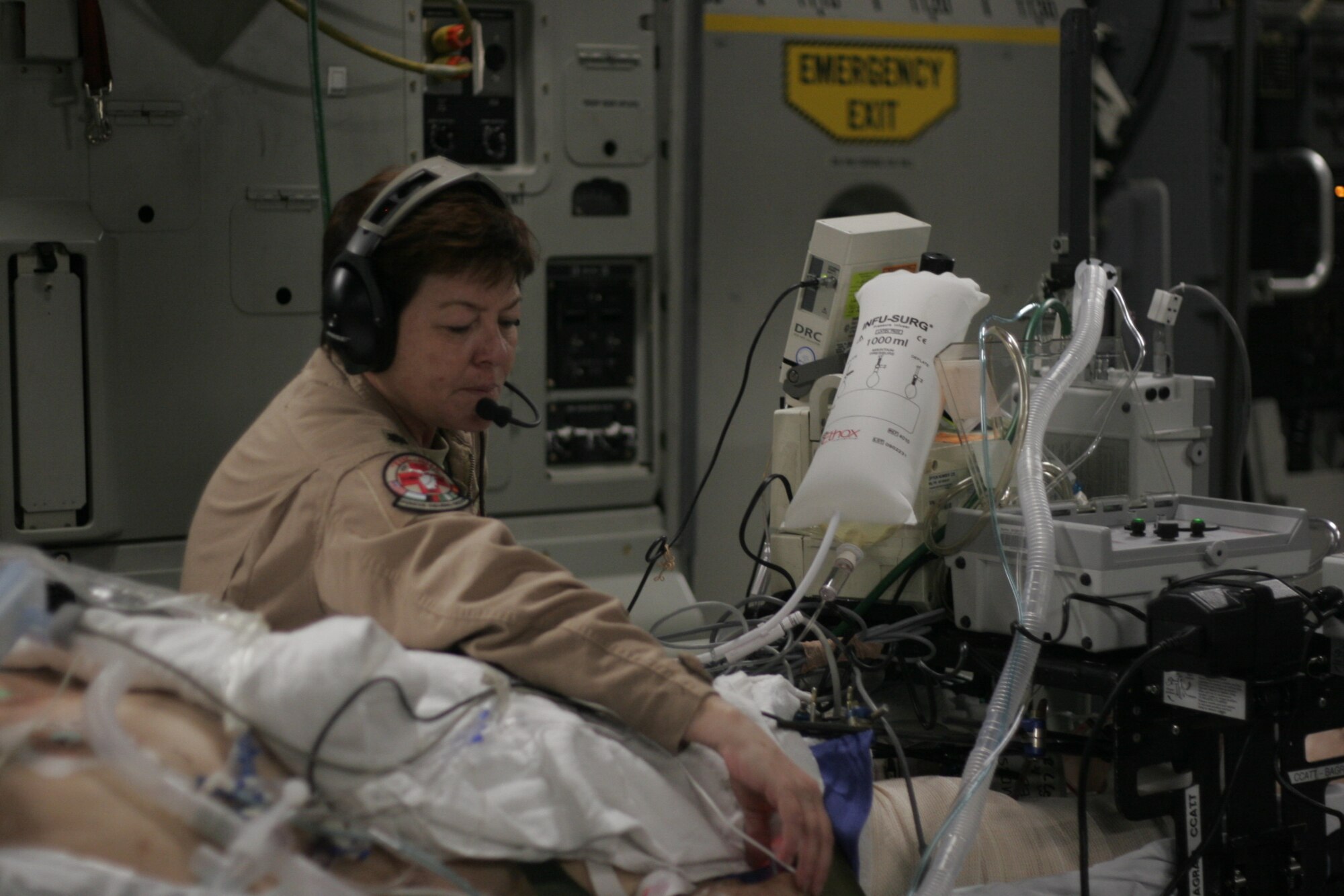 BAGRAM AIR FIELD, Afghanistan -- Lt. Col. Patricia Fulton, a medical crew director with the 455th Expeditionary Aeromedical Evacuation Flight, tends to a critical care patient.  Aeromedical evacuation crews performed 19,025 patient movements in 2009, and have evacuated more than 140,000 patients since the beginning of Operation Iraqi Freedom. (U.S. Air Force photo by 2nd Lt. Daniel Riley)