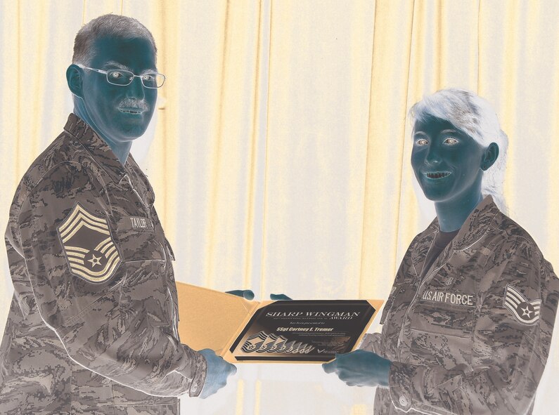 Chief Master Sgt. Gregory Taylor, 908 Aircraft Maintenance Squadron, presents Staff Sgt. Cortney Tremer of the 908 ASTS with the Sharp Wingman of the Quarter Award. 