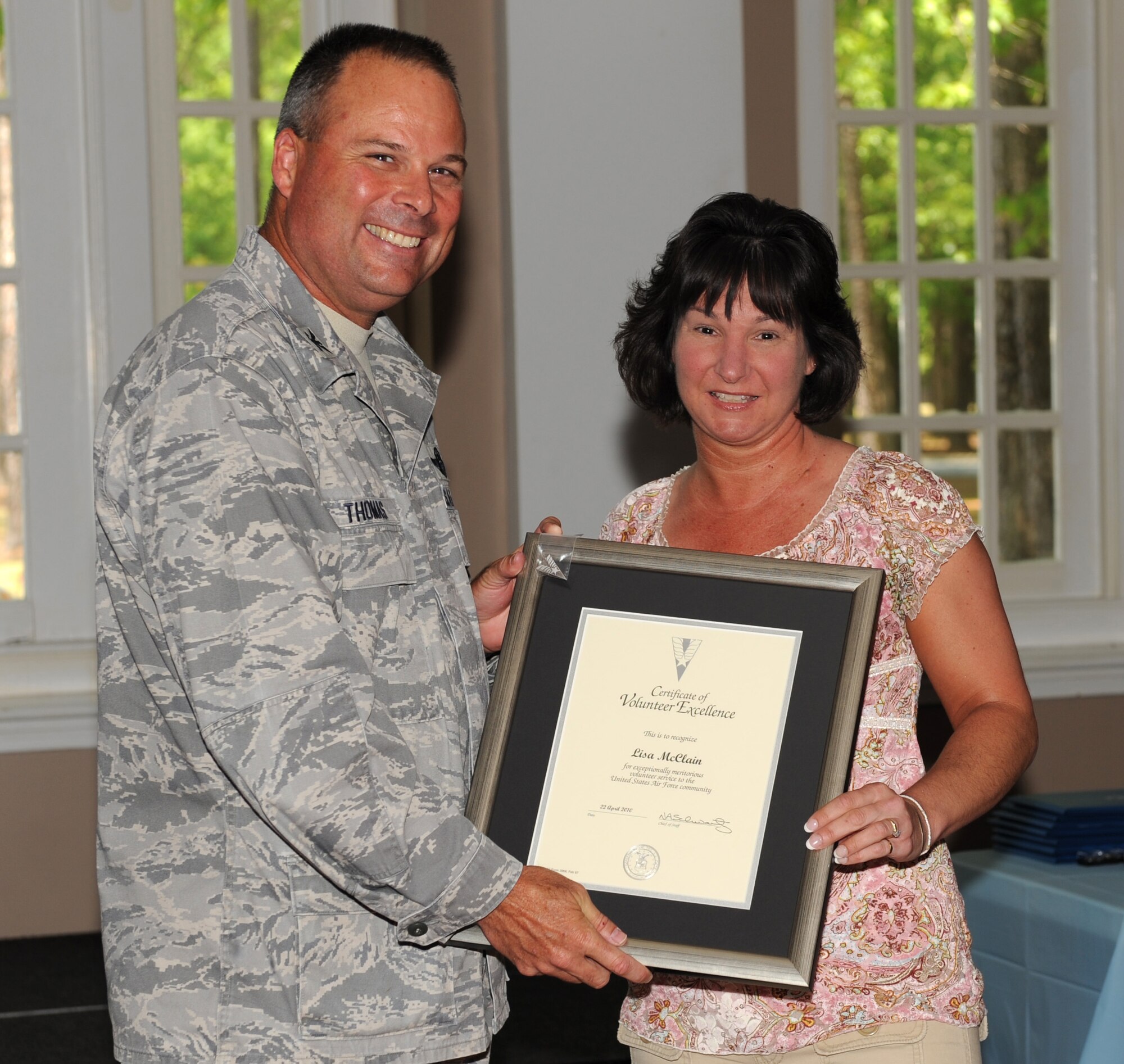SEYMOUR JOHNSON AIR FORCE BASE, N.C. -- Col. William Thomas presents Lisa McClain with the lifetime presidential service award here April 22, 2010. Ms. Booth received the award for her work at the Airman's Attic, Thrift Shop and with the Key Spouse program. Colonel Thomas is the 4th Mission Support Group commander. (U.S. Air Force photo/Airman 1st Class Gino Reyes)