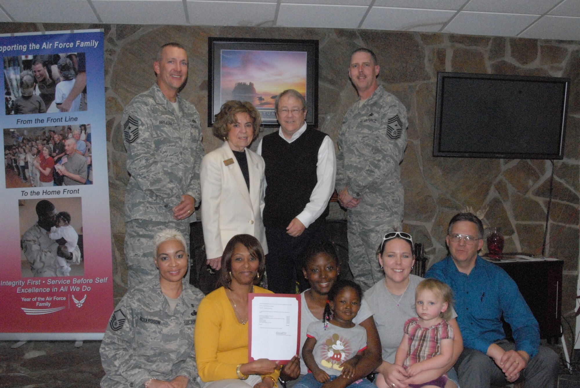 Chief Master Sgt. Mark Brejcha, 412th Test Wing, command chief, stands next to Fran Stewart, Antelope Valley Chapter of the Red Cross, executive director, along with several Edwards residents at the Airmen Family Readiness Center April 27.  The local Red Cross chapter donated more than $18,000 to Edwards which will be used to help local programs for Airmen and their families.  (Air Force photo by Kenji Thuloweit)