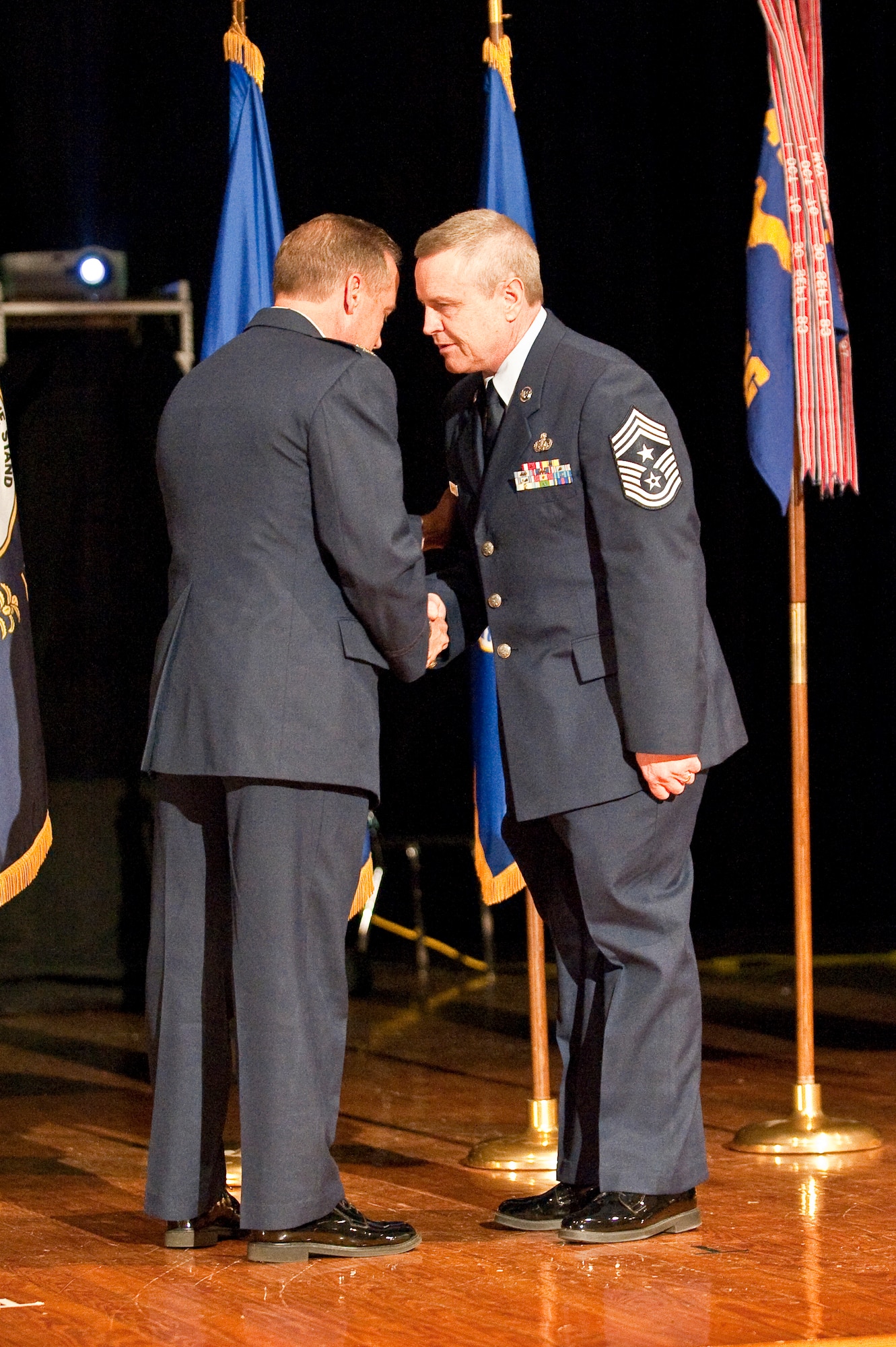 Col. Greg Nelson (left), commander of the Kentucky Air Guard's 123rd Airlift Wing, congratulates the new wing command chief master sergenat, Chief Master Sgt. Curtis Carpenter, during a change-of-responsibility ceremony held April 17, 2010 at Louisville Male High School in Louisville, Ky. Chief Carpenter replaces former Command Chief Master Sgt. Thomas Downs Jr., who passed away in December after nearly 32 years of service in the Kentucky Air National Guard. (U.S. Air Force photo/Maj. Dale Greer)