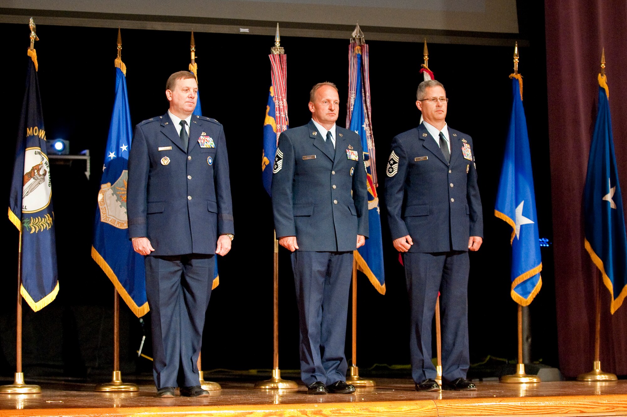 The Kentucky Air Guard welcomed its newest state command chief master sergeant, Chief Master Sgt. James Smith (right), during a change-of-responsibility ceremony held April 17, 2010 at Louisville Male High School in Louisville, Ky. Also pictured are Kentucky's adjutant general, Maj. Gen. Edward Tonini (left) and former State Command Chief Master Sgt. Mark Grant (center), who is retiring from the Kentucky Air Guard after 30 years of service. (U.S. Air Force photo/Maj. Dale Greer)
