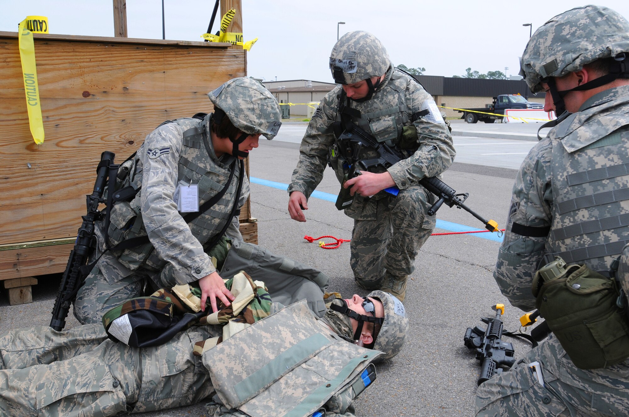 Airmen from the notional 104th Air Expeditionary Wing render simulated self-aid and buddy care to a wounded troop April 24, 2010 following an enemy attack during the Operational Readiness Exercise at the Gulfport Combat Readiness Training Center in Gulfport, Miss. (U.S. Air Force photo/Tech. Sgt. Dennis Flora)