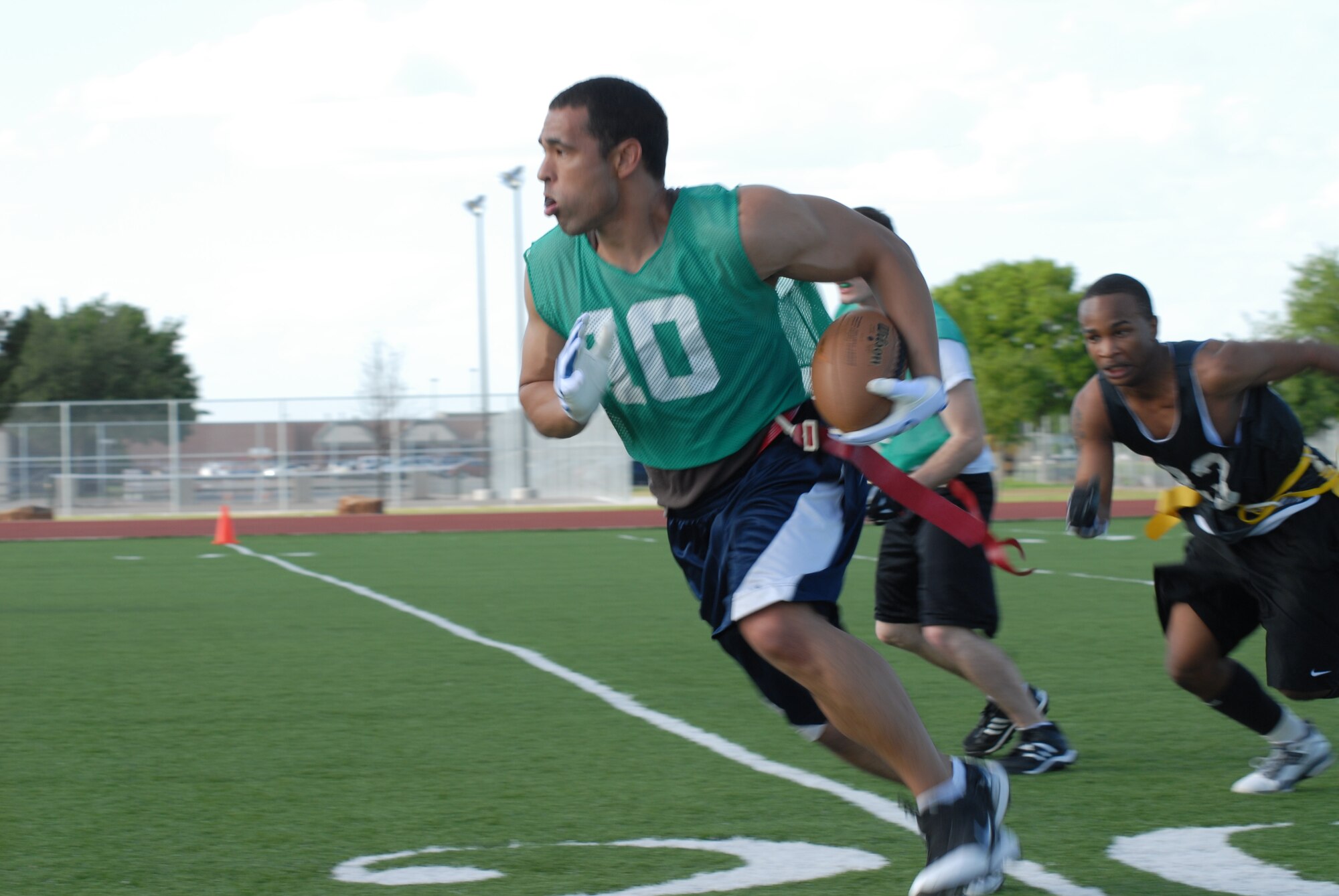 56 Council teammate Brandon Foster, 17th Security Forces Squadron, takes it from the 20 yard line during their game against ACE April 23. 56 Council shutout Ace 27-0. (U.S. Air Force photo/Senior Airman Tong Duong)