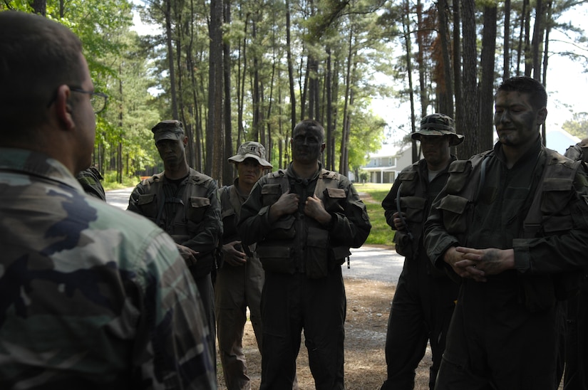 A U.S. Air Force Survival, Evasion, Resistance and Escape specialist provides pilots and aircrew with critique at the end of a long day of SERE refresh training at the Naval Weapons Station’s Marrington Plantation April 22, 2010. The training is only a refresher course from the original 19-day course that pilots and aircrew were required to complete initially. The courses foundation is based on the code of conduct, but SERE training itself is about maintaining life and returning with honor.  Due to the nature of SERE training, anonymity is important, therefore, the names of the SERE instructors have been withheld. The SERE specialist pictured is with the 437th Operations Support Squadron. (U.S. Air Force Photo/Airman 1st Class Lauren Main)