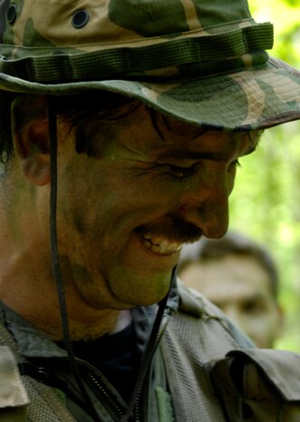 U.S. Air Force Tech. Sgt. Fred Fox takes the edge off with a laugh during the Survival, Evasion, Resistance and Escape refresher course at the Naval Weapons Station’s Marrington Plantation April 22, 2010. This refresher course is mandatory for pilots and aircrew to complete once every three years. The training included proper evasion and recovery techniques as well as a role play scenario. During the scenario, the crews put to practice their pre-existing training and were critiqued on their skills. Sergeant Fox is a loadmaster with the 317th Airlift Squadron. (U.S. Air Force Photo/Airman 1st Class Lauren Main)