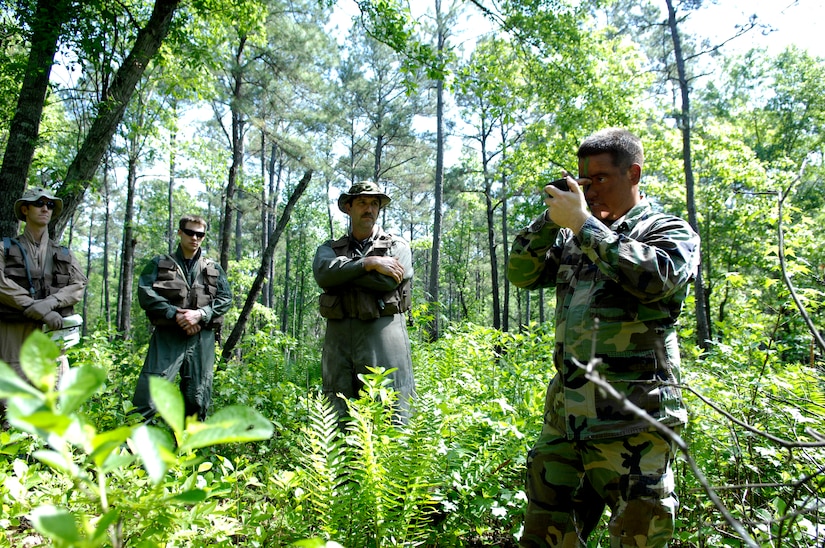 A U.S. Air Force Survival, Evasion, Resistance and Escape specialist demonstrates the proper way to apply camouflage face paint during SERE refresh training for pilots and aircrew at the Naval Weapons Station’s Marrington Plantation April 22, 2010. This refresher course is a full day worth of instruction which begins in the classroom and ends with boots in the dirt. The aircrew and pilots were given a scenario in which they had to evade capture, navigate their way through the woods to specific rally points and eventually to a simulated rescue point. A SERE specialist said, “We will kick in doors and do what we have to do to make sure you come home; whatever it takes.”  Due to the nature of SERE training, anonymity is important, therefore, the names of the SERE instructors have been withheld. The SERE specialist pictured is with the 437th Operations Support Squadron. (U.S. Air Force Photo/Airman 1st Class Lauren Main)