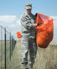 SCHRIEVER AIR FORCE BASE, Colo. -- Master Sgt. John Richardson, SIDC First Sergeant, scoured the landscape alongside Curtis Road April 21 snatching up trash and debris. Sergeant Richardson took part in SIDC's Earth Day highway clean up along with members of the Space Innovation and Development Center.  (U.S. Air Force photo/Scott Prater)