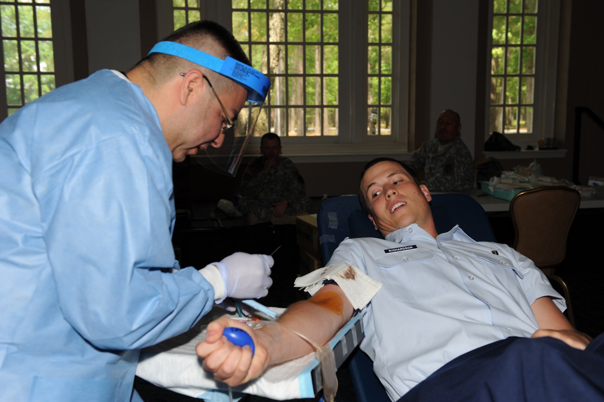 SEYMOUR JOHNSON AIR FORCE BASE, N.C. --  Army Spc. Jerry Huertay prepares to draw blood from Capt. Jordan Richardson here April 26, 2010. Specialist Huertay draws approximately one pint of blood, which will be used for injured servicemembers supporting operations Iraqi and Enduring Freedom. Specialist Huertay, Fort Bragg combat medic, hails from San Antonio and Captain Richardson, 4th Medical Operations Squadron physical therapist, is a native of Humboldt, Tenn. (U.S. Air Force photo/Airman 1st Class Gino Reyes)