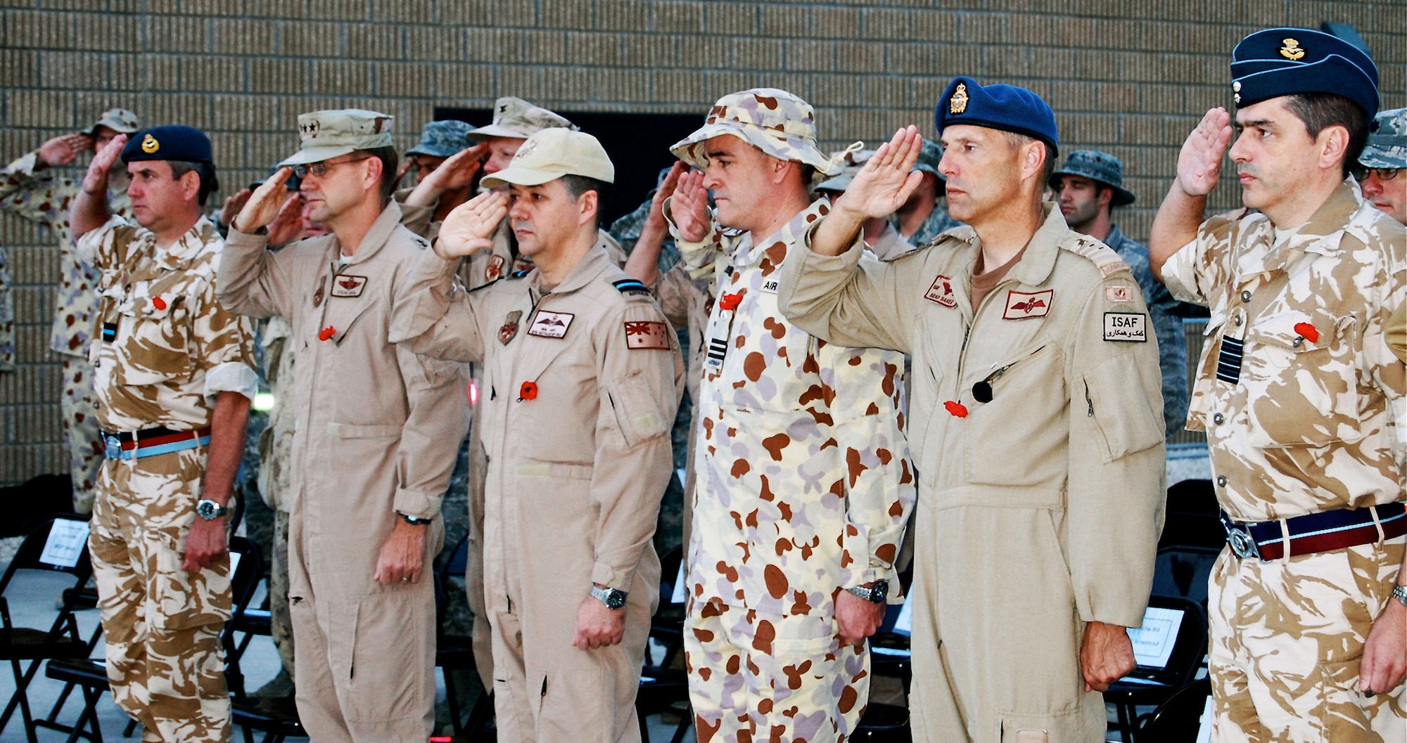 Senior officers from the air components of the United Kingdom, the United States, Australia, Canada and France present arms during the Australian National Anthem April 25, 2010, in Southwest Asia. Each wore a red poppy, the traditional symbol of remembrance for Australian and New Zealand Army Corps Day. (U.S. Air Force photo/Maj. Chad Steffey)