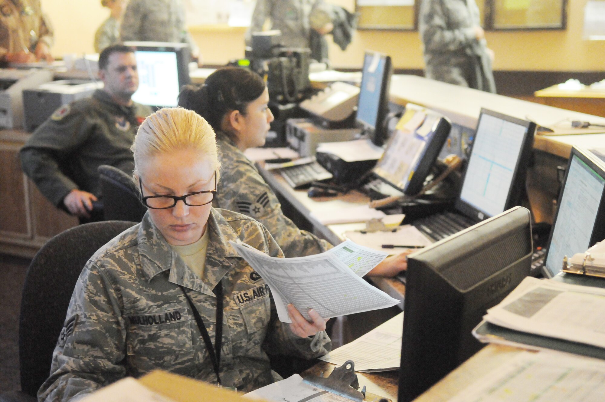 Senior Airman Maudraguine Mulholland reviews paperwork for pilots April 22, 2010, Eielson Air Force Base, Alaska. "One-Charlies" make sure the pilots step on time and are qualified for their flight. Airman Mulholland is assigned to Seymour Johnson Air Force Base, North Carolina 4th Air Combat Command. (U.S. Air Force photo by Janine Thibault)