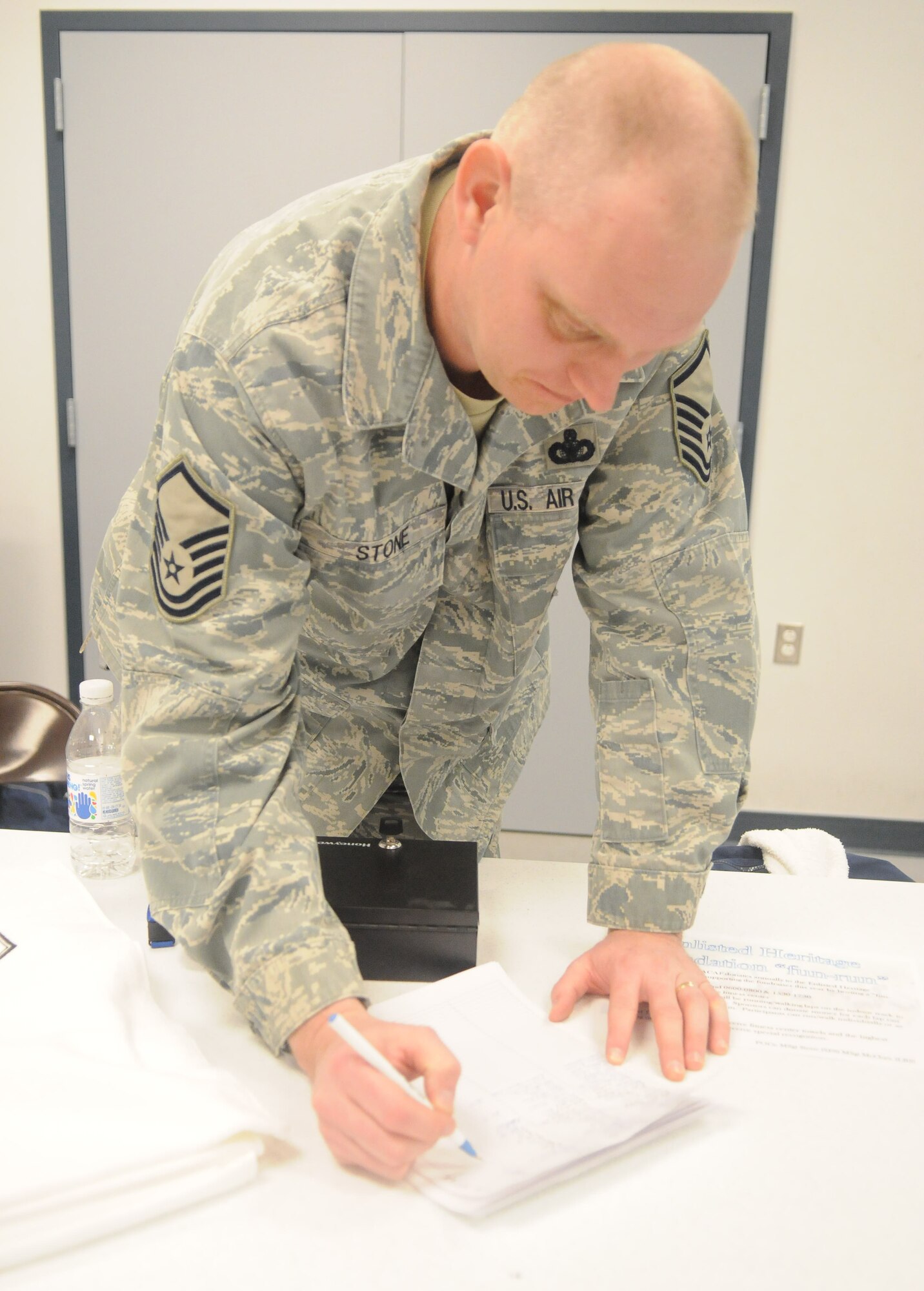 Master Sgt. Carrol Stone calculates the laps completed by the runners April 22, 2010, Eielson Air Force Base.  Altogether, 886 laps were completed by approximately 55 volunteers. The volunteers raised $1,360 with help from about 200 supporters. Sergeant Stone is assigned to the 354th Security Forces Squadron. (U.S. Air Force photo by/Airman 1st Class Janine Thibault)