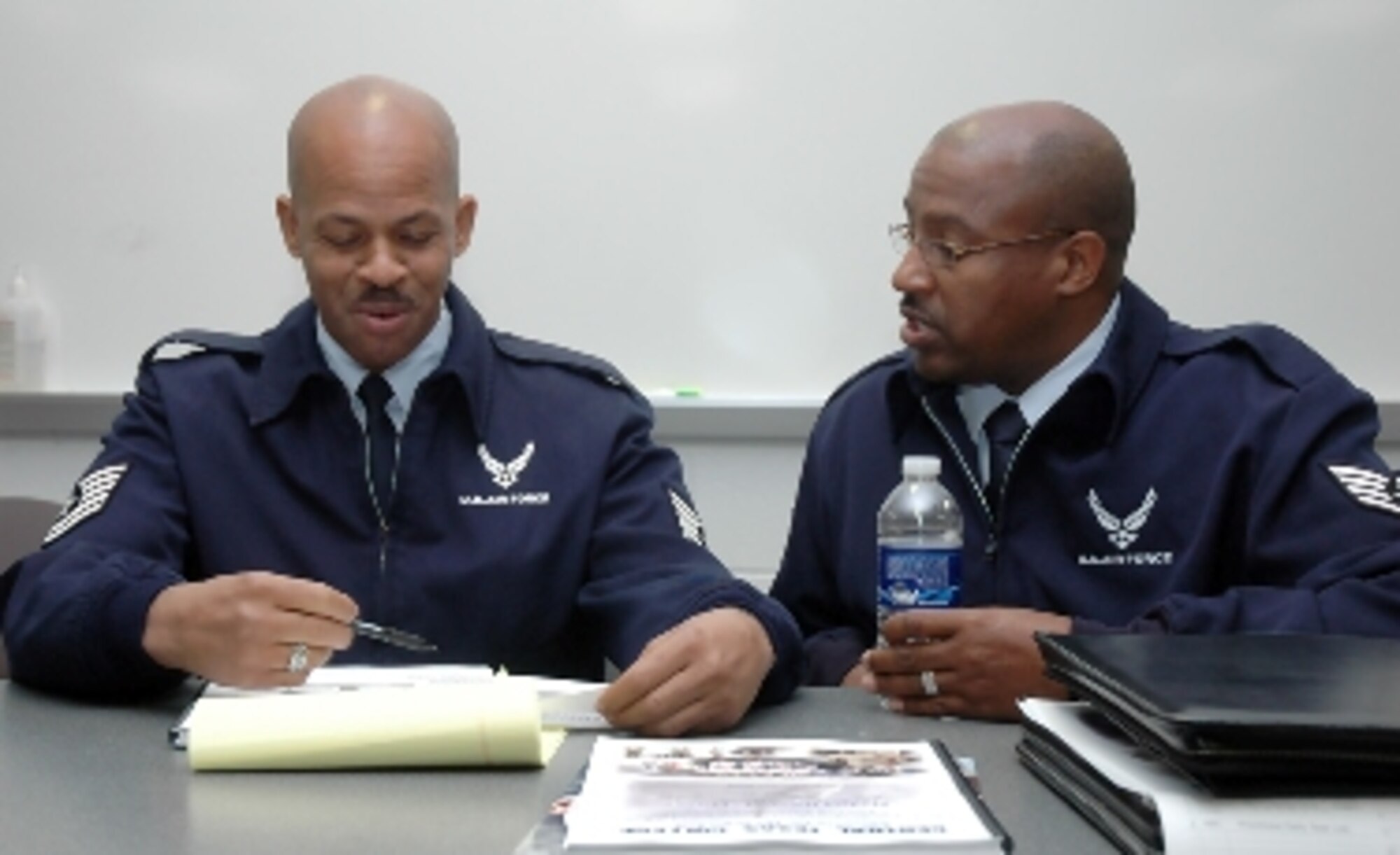 Tech.  Sgt. Roosevelt Oggs and Staff Sgt. Douglas Hicks discuss issues of communication during the NCO Leadership Development Course.  (U.S. Air Force photo/Travon Dennis)