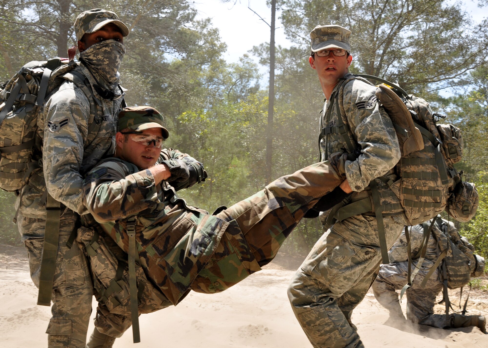 EGLIN AIR FORCE BASE, Fla. – Airmen from the 316th Security Forces Squadron (Andrews AFB, Washington D.C.) carry an “injured” wingman away from the blast site of an improvised explosive device during the Counter-IED portion of Brave Defenders training April 22. The team was the first to experience Counter-IED, the newest addition to the training. Brave Defenders is a 16-day program training security forces members from various bases across the country in preparation for deployment to combat zones. The course opened here in 2002 and was established by Air Force Materiel Command to satisfy security forces training requirements in an expeditionary environment. (U.S. Air Force photo/ Airman 1st Class Anthony Jennings)