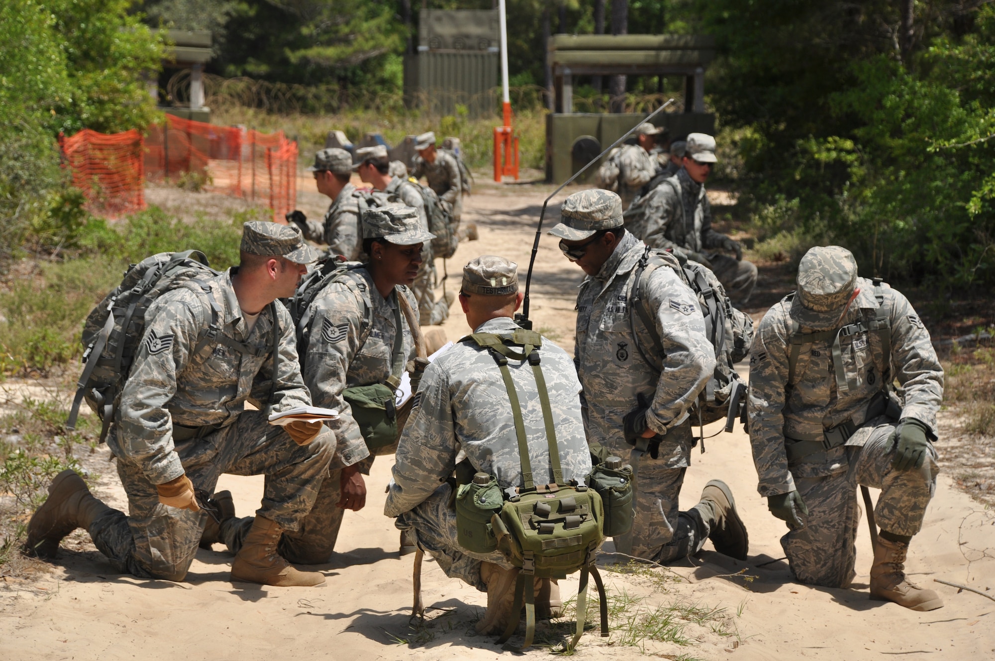 EGLIN AIR FORCE BASE, Fla. – Staff Sgt. Eric Testerman, 96th Ground Combat Training Squadron instructor, discusses the plan of action with Airmen from the 316th Security Forces Squadron (Andrews AFB, Washington D.C.) after they discovered a potential improvised explosive device during the Counter-IED portion of Brave Defenders training April 22. The team was the first to experience Counter-IED, the newest addition to the training. Brave Defenders is a 16-day program training security forces members from various bases across the country in preparation for deployment to combat zones. The course opened here in 2002 and was established by Air Force Materiel Command to satisfy security forces training requirements in an expeditionary environment. (U.S. Air Force photo/ Airman 1st Class Anthony Jennings)