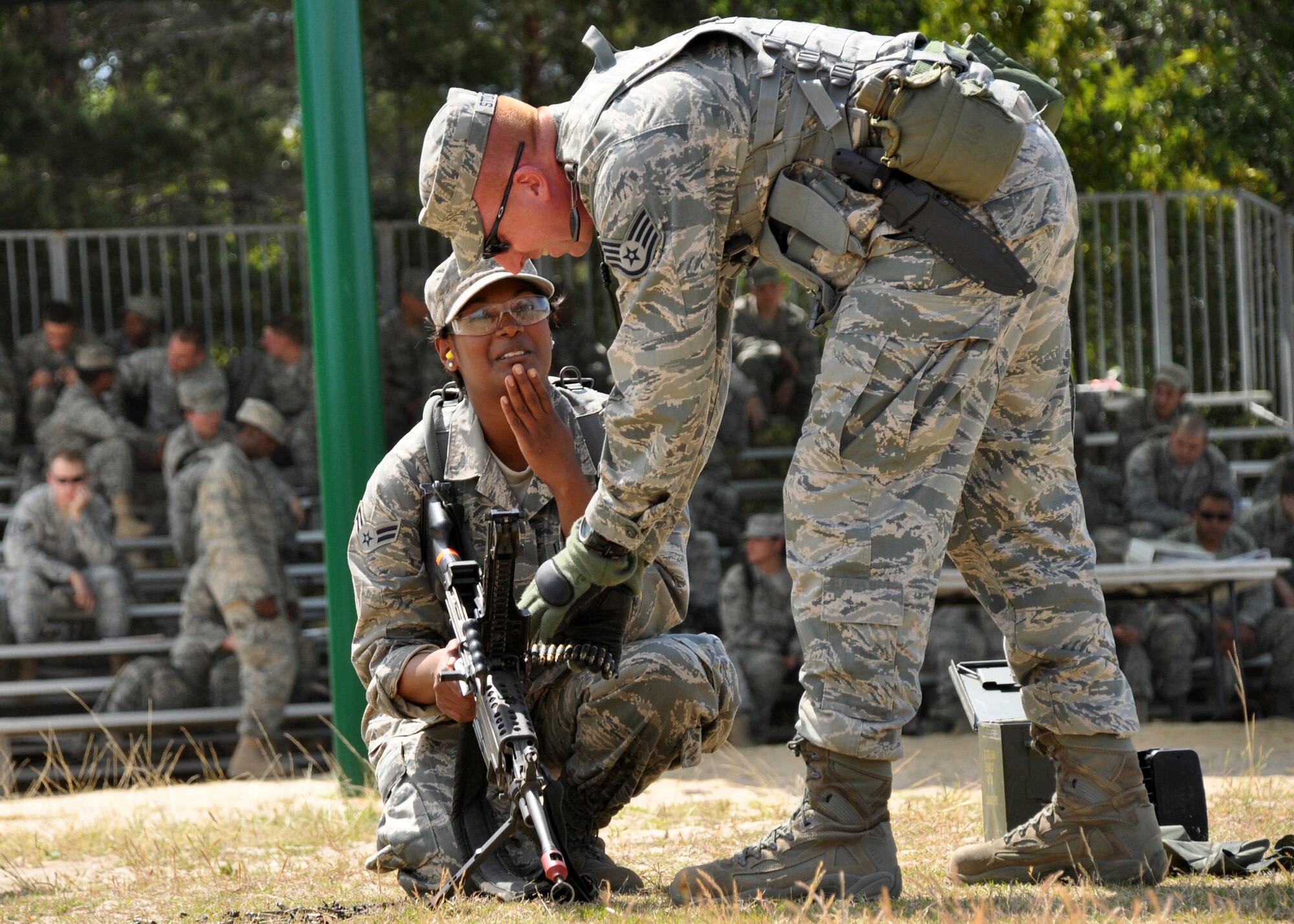 EGLIN AIR FORCE BASE, Fla. – A security forces Airman gets help from her instructor with loading blanks into an M249 during the weapons familiarization portion of Brave Defenders training April 22. The 16-day program trains security forces members from various bases across the country for deployment to combat zones. The course opened here in 2002 and was established by Air Force Materiel Command to satisfy security forces training requirements in an expeditionary environment. (U.S. Air Force photo/ Airman 1st Class Anthony Jennings)