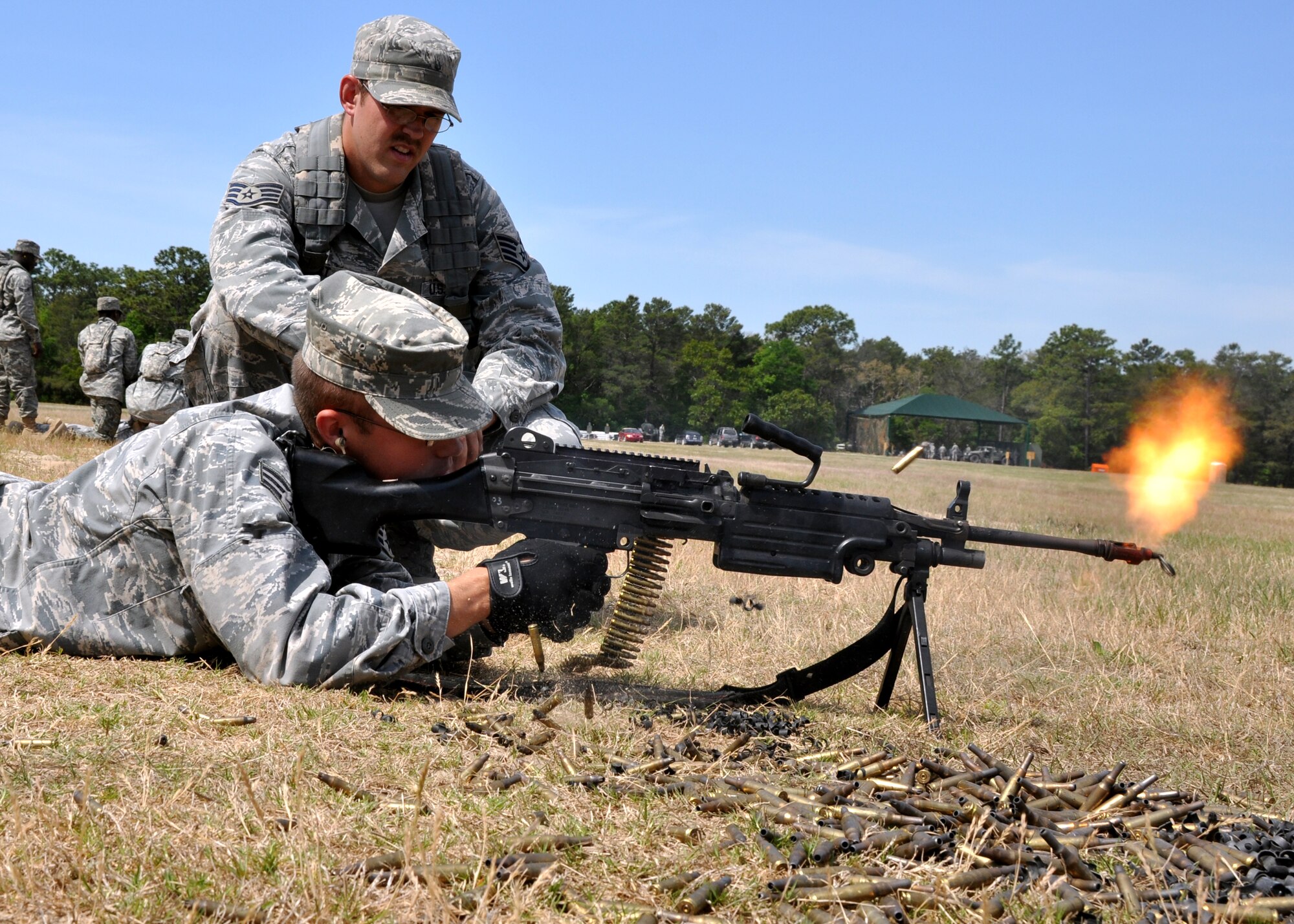 EGLIN AIR FORCE BASE, Fla. – A security forces Airman fires blanks from an M249 under the watchful eye of Staff Sgt. Jarrod Stewart, 96th Ground Combat Training Squadron instructor, during the weapons familiarization portion of Brave Defenders training April 22. The 16-day program trains security forces members from various bases across the country for deployment to combat zones. The course opened here in 2002 and was established by Air Force Materiel Command to satisfy security forces training requirements in an expeditionary environment. (U.S. Air Force photo/ Airman 1st Class Anthony Jennings)