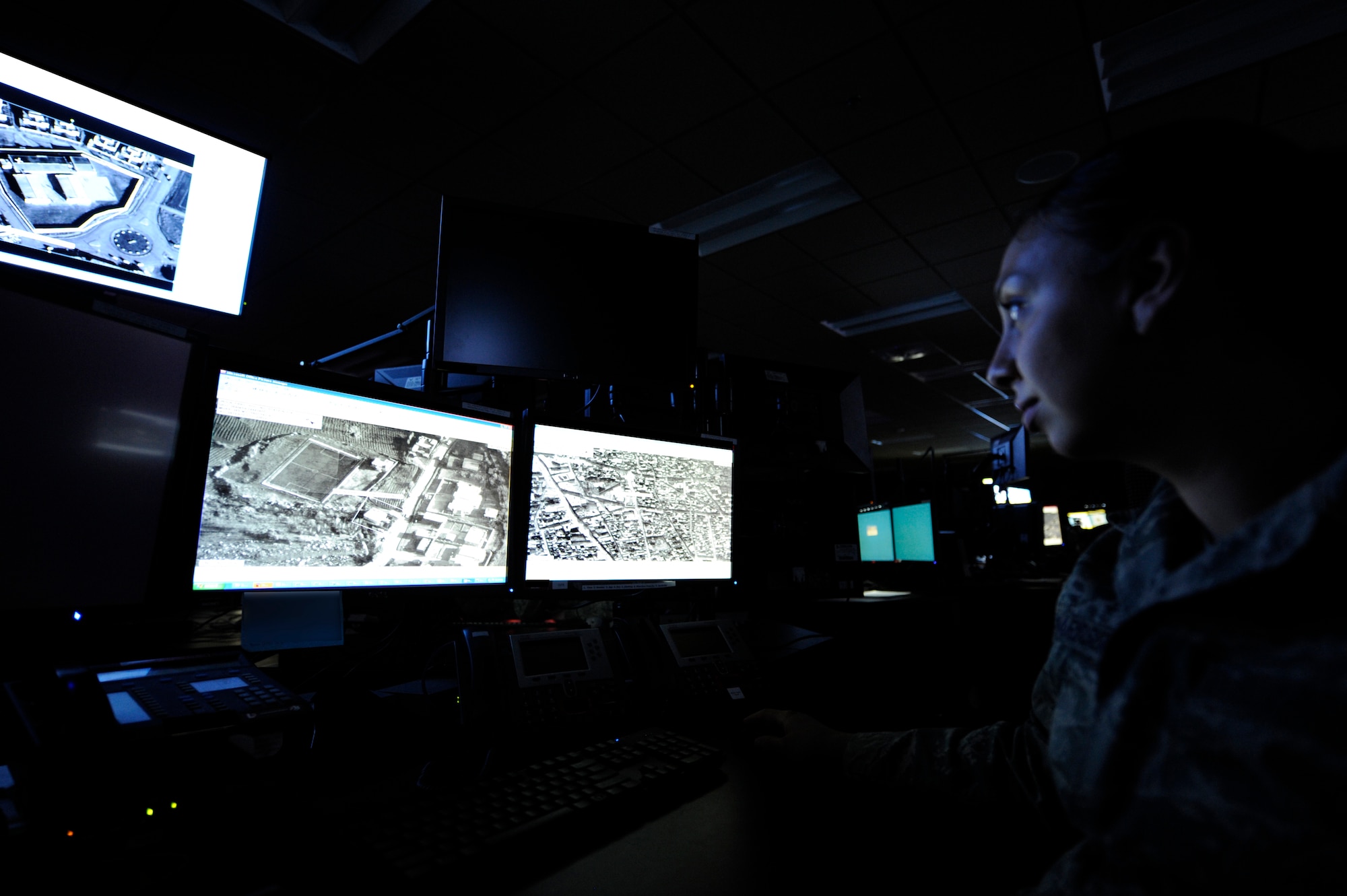 LANGLEY AIR FORCE BASE, Va. -- Senior Airman Julia Richardson, 10th Intelligence Squadron cyber transport technician, analyses computer imagery on the operations floor of the new 497th Intelligence, Surveillance and Reconnaissance Group building April 21. The complex is four times larger than prior facilities, housing assets and more than 700 personnel from six different buildings, now centralized into one location. (U.S. Air Force illustration/ Senior Airman Dana Hill)