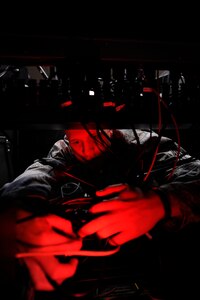 LANGLEY AIR FORCE BASE, Va. -- Senior Airman Ryan Albert, 10th Intelligence Squadron electrical power production journeyman, installs computer systems on the operations floor of the new 497th Intelligence, Surveillance and Reconnaissance Group building April 21. The complex is four times larger than prior facilities, hosting assets and more than 700 personnel from six different buildings, now centralized into one location. (U.S. Air Force photo/ Senior Airman Dana Hill)