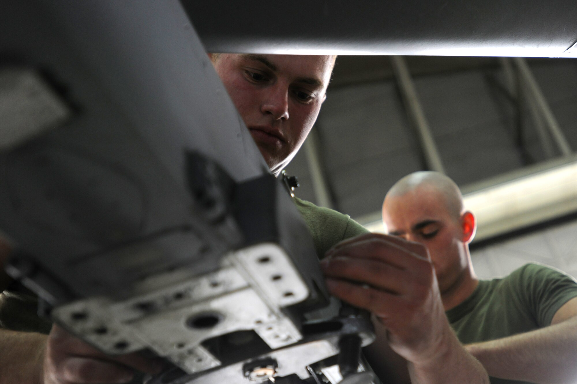 (L to R) U.S. Marine Lance Corporals Jonathan Jolly and Joseph Anderson replace a sole plate on the rack of an AV-8B Harrier for a quarterly inspection in preparation for wing removal during RED FLAG-Alaska 10-2, April 27, 2010, Eielson Air Force Base, Alaska. RF-A provides unique opportunities to integrate various forces into joint, coalition and bilateral training from simulated forward operating bases. Corporal Jolly and Anderson are both assigned to VMA-211, Marine Corps Air Station, Yuma, AZ.  (U.S. Air Force photo by Staff Sgt. Tia Wilson)