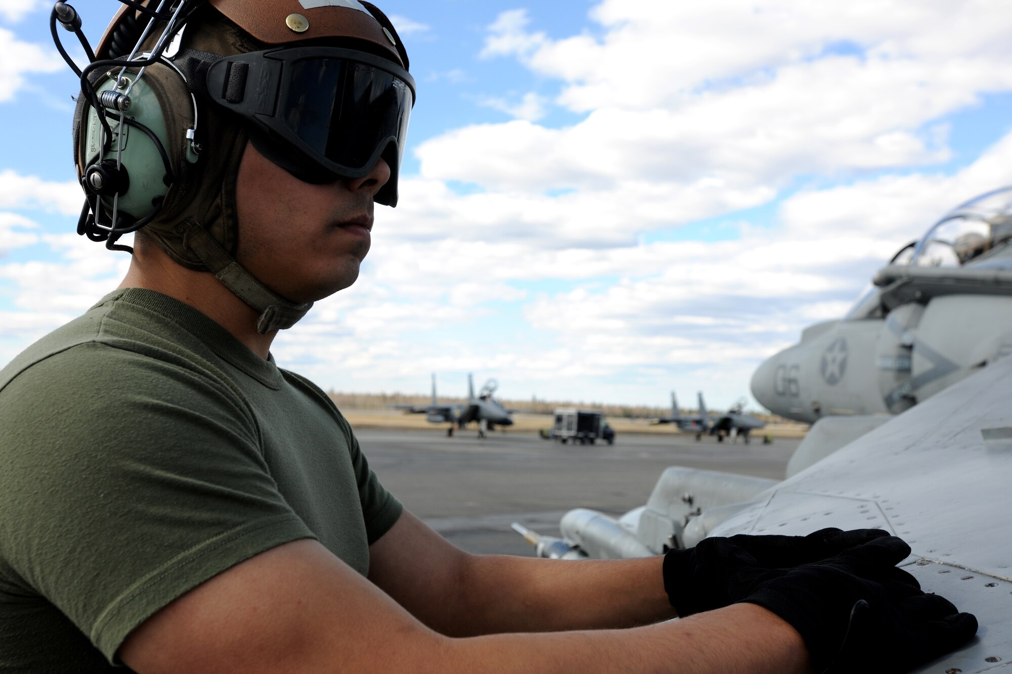 U.S. Marine Cpl. Jason Alfaro performs pre-flight inspections on an AV-8B Harrier during RED FLAG-Alaska 10-2, April 27, 2010, Eielson Air Force Base, Alaska.  RF-A is a Pacific Air Forces-directed field training exercise for United States and coalition forces under simulated combat conditions.  Corporal Alfaro is assigned to VMA-211, Marine Corps Air Station, Yuma, AZ.  (U.S. Air Force photo by Staff Sgt. Tia Wilson)
