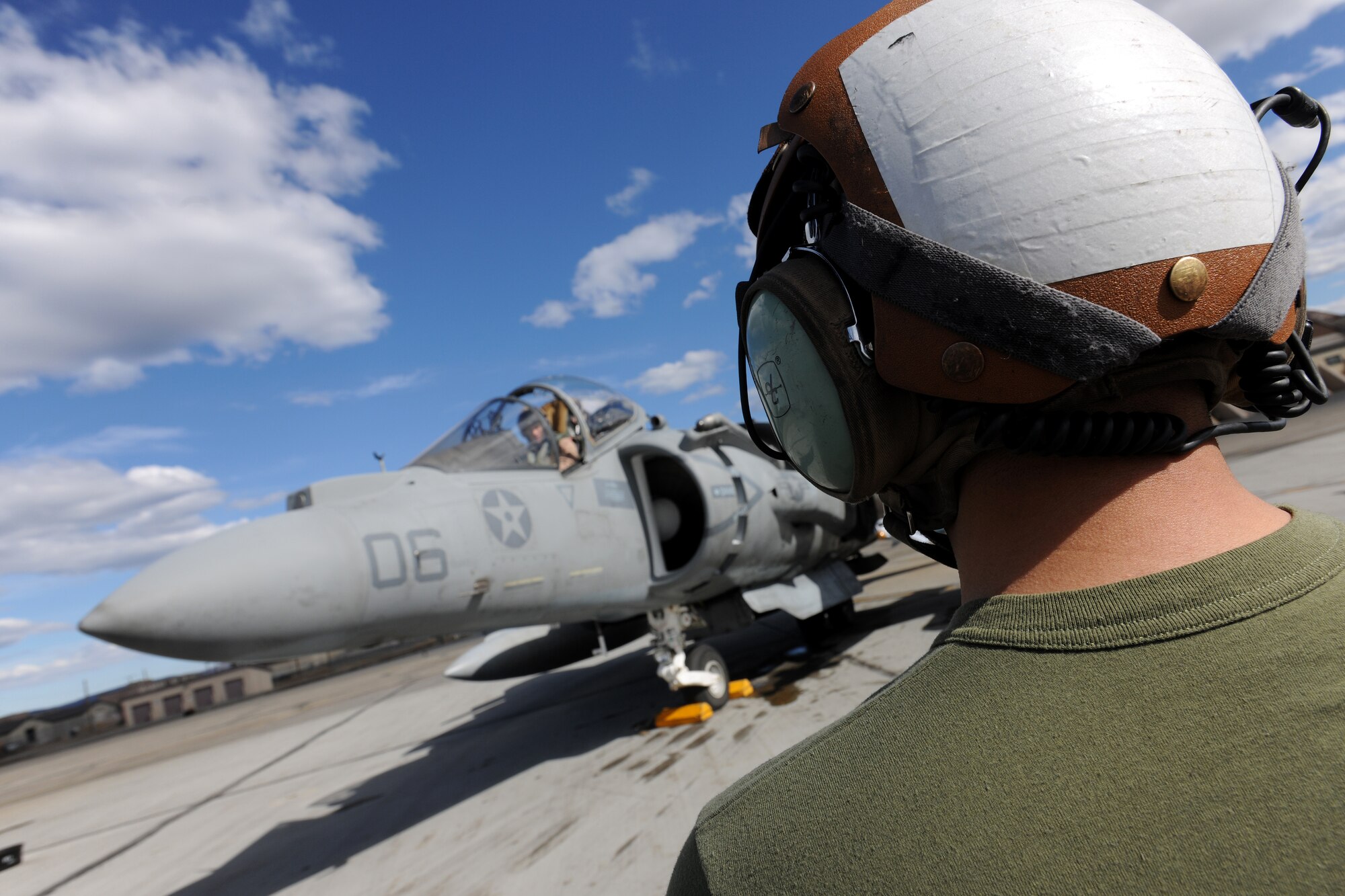 U.S. Marine Cpl. Jason Alfaro prepares to marshal an AV-8B Harrier during RED FLAG-Alaska 10-2, April 27, 2010, Eielson Air Force Base, Alaska.  RF-A provides unique opportunities to integrate various forces into joint, coalition and bilateral training from simulated forward operating bases.  Corporal Alfaro is assigned to  VMA-211, Marine Corps Air Station, Yuma, AZ.  (U.S. Air Force photo by Staff Sgt. Tia Wilson)