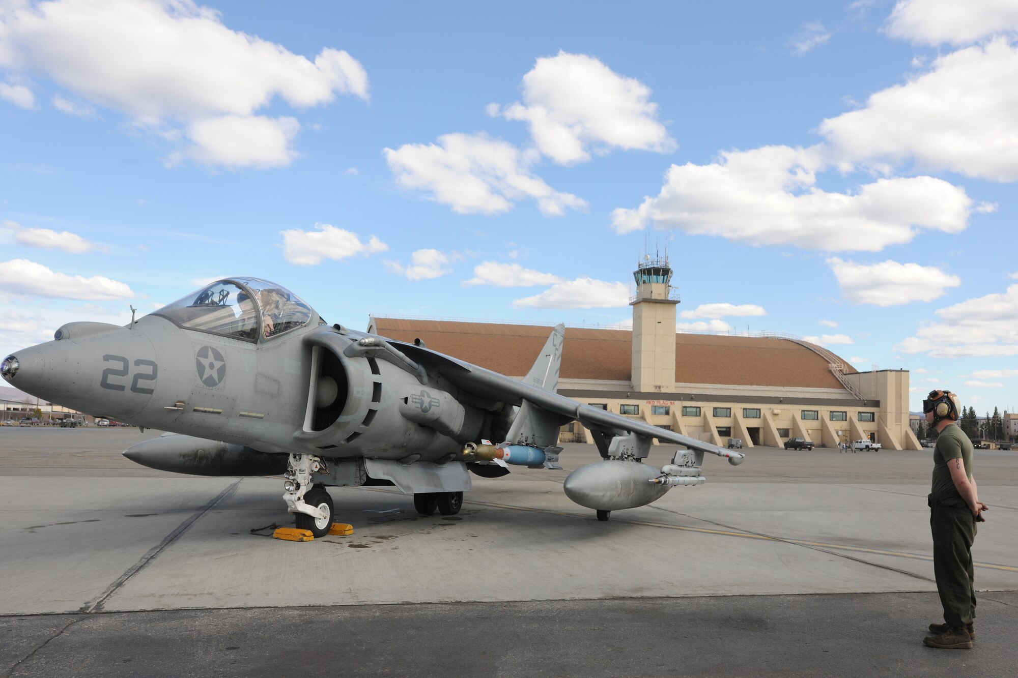 U.S. Marine Lance Cpl. Matt Eason prepares to marshal an AV-8B Harrier during RED FLAG-Alaska 10-2, April 27, 2010, Eielson Air Force Base, Alaska.  RF-A provides unique opportunities to integrate various forces into joint, coalition and bilateral training from simulated forward operating bases.  Lance Corporal Eason is assigned to  VMA-211, Marine Corps Air Station, Yuma, AZ.  (U.S. Air Force photo by Staff Sgt. Tia Wilson)