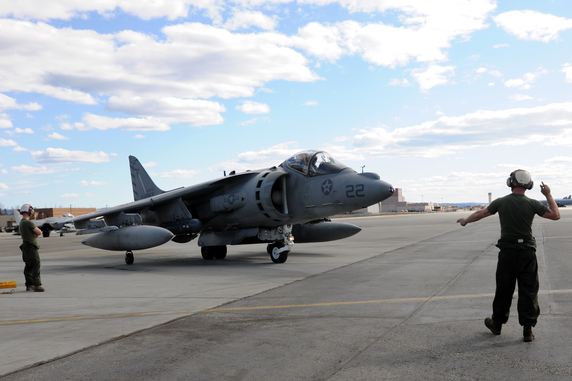 U.S. Marine Lance Cpl. Matt Eason marshals an AV-8B Harrier during RED FLAG-Alaska 10-2, April 27, 2010, Eielson Air Force Base, Alaska.  RF-A provides unique opportunities to integrate various forces into joint, coalition and bilateral training from simulated forward operating bases.  Lance Corporal Eason is assigned to  VMA-211, Marine Corps Air Station, Yuma, AZ.  (U.S. Air Force photo by Staff Sgt. Tia Wilson)